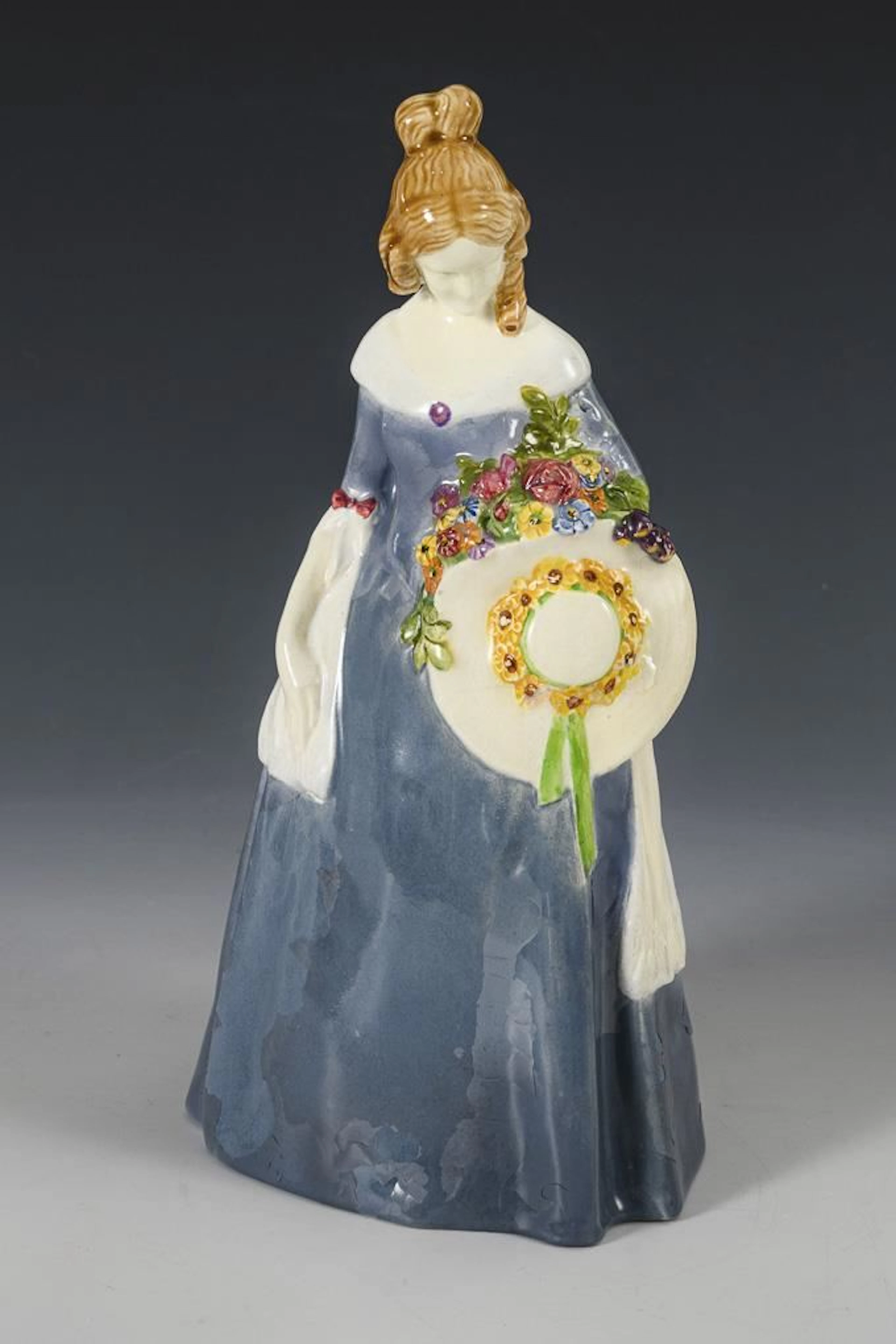 Woman in a blue dress and hat. Vienna Art Ceramics Workshop Busch & Ludescher.