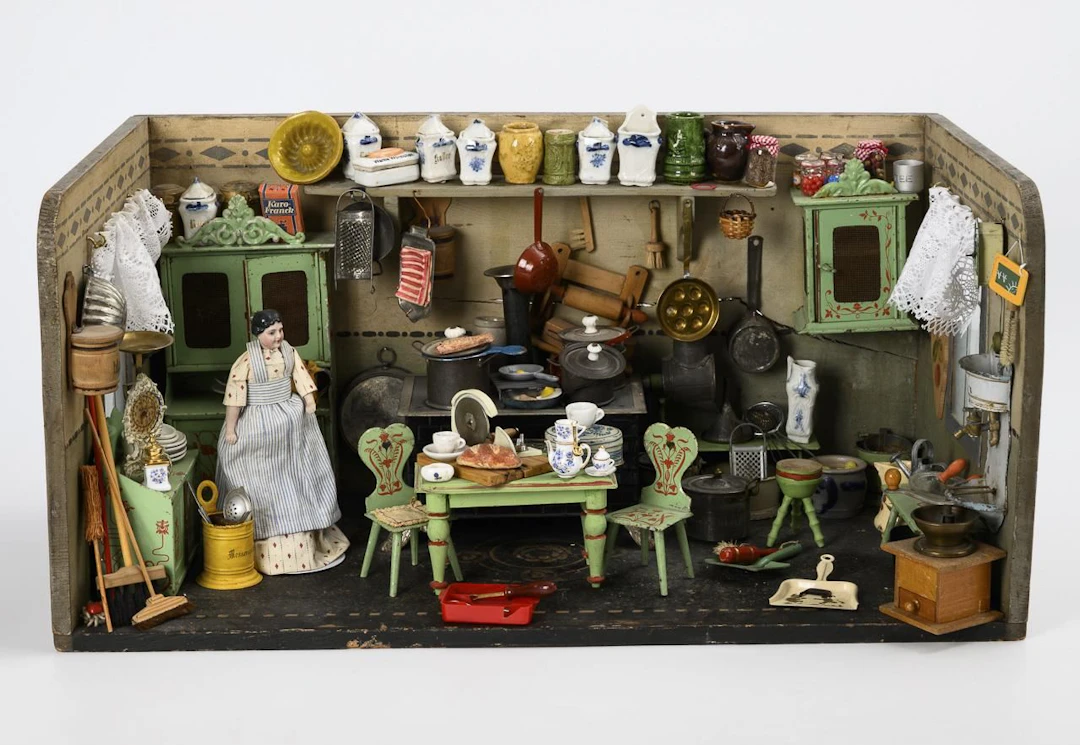 Dollhouse kitchen with green tin furniture.