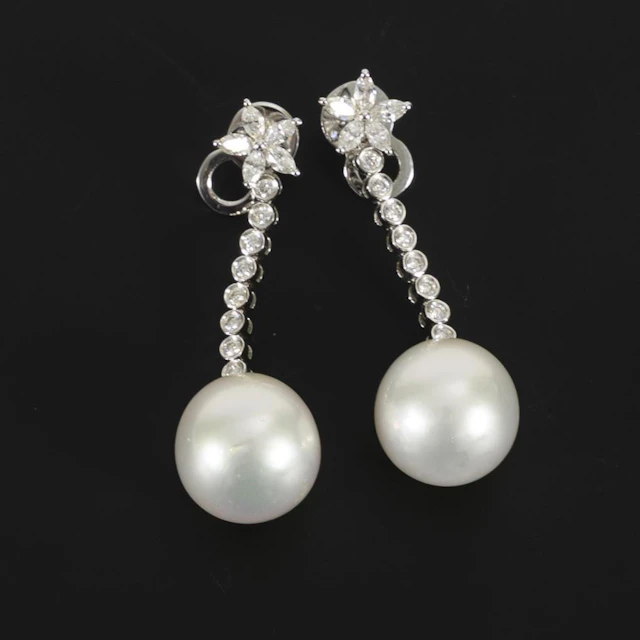 High-quality dangling earrings with pearls, likely South Sea pearls.