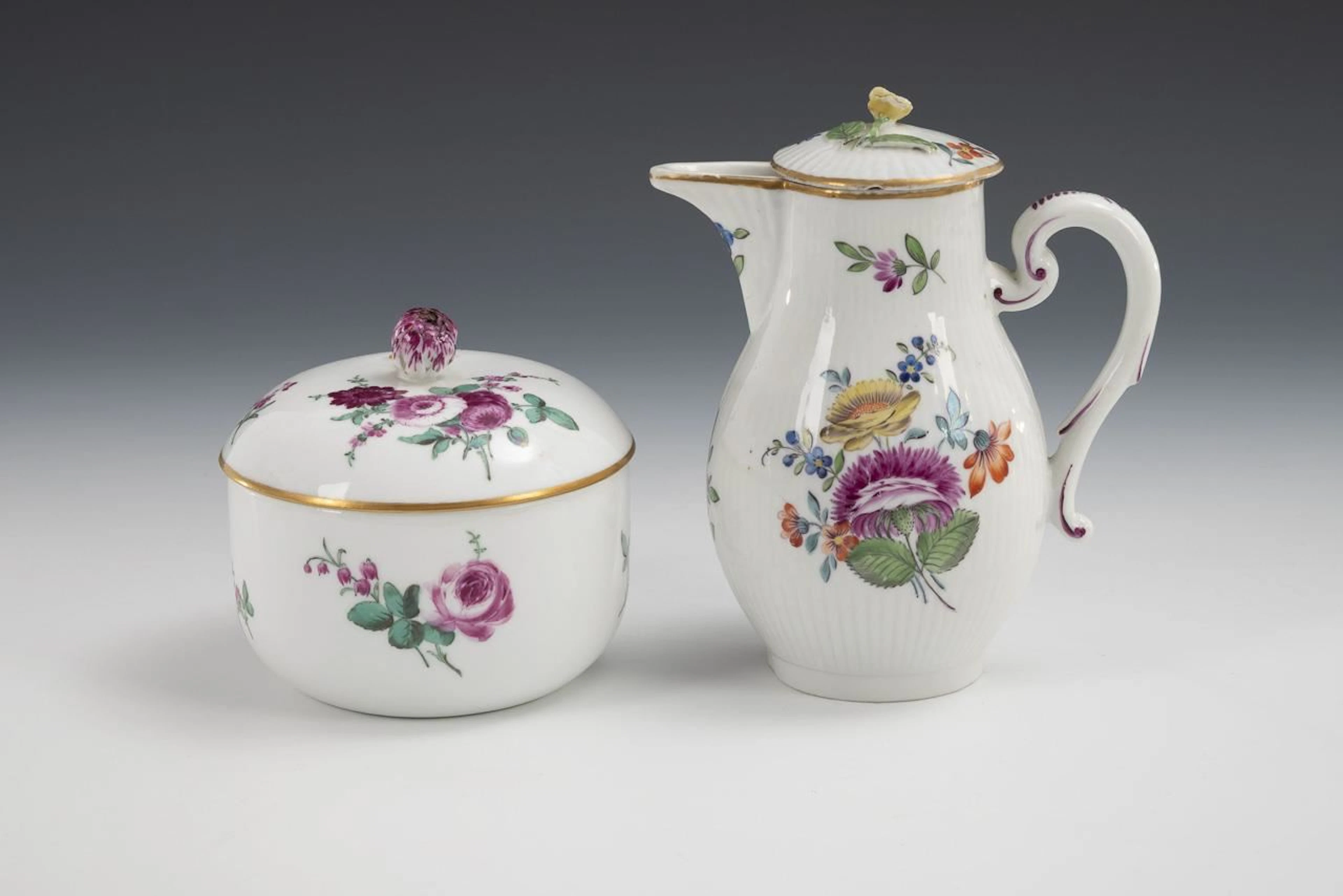 Baroque sugar bowl and small pitcher with floral motifs.