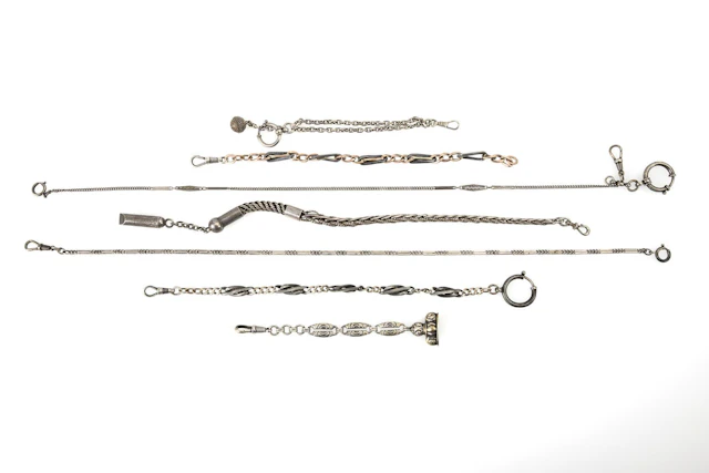 6 silver watch chains.