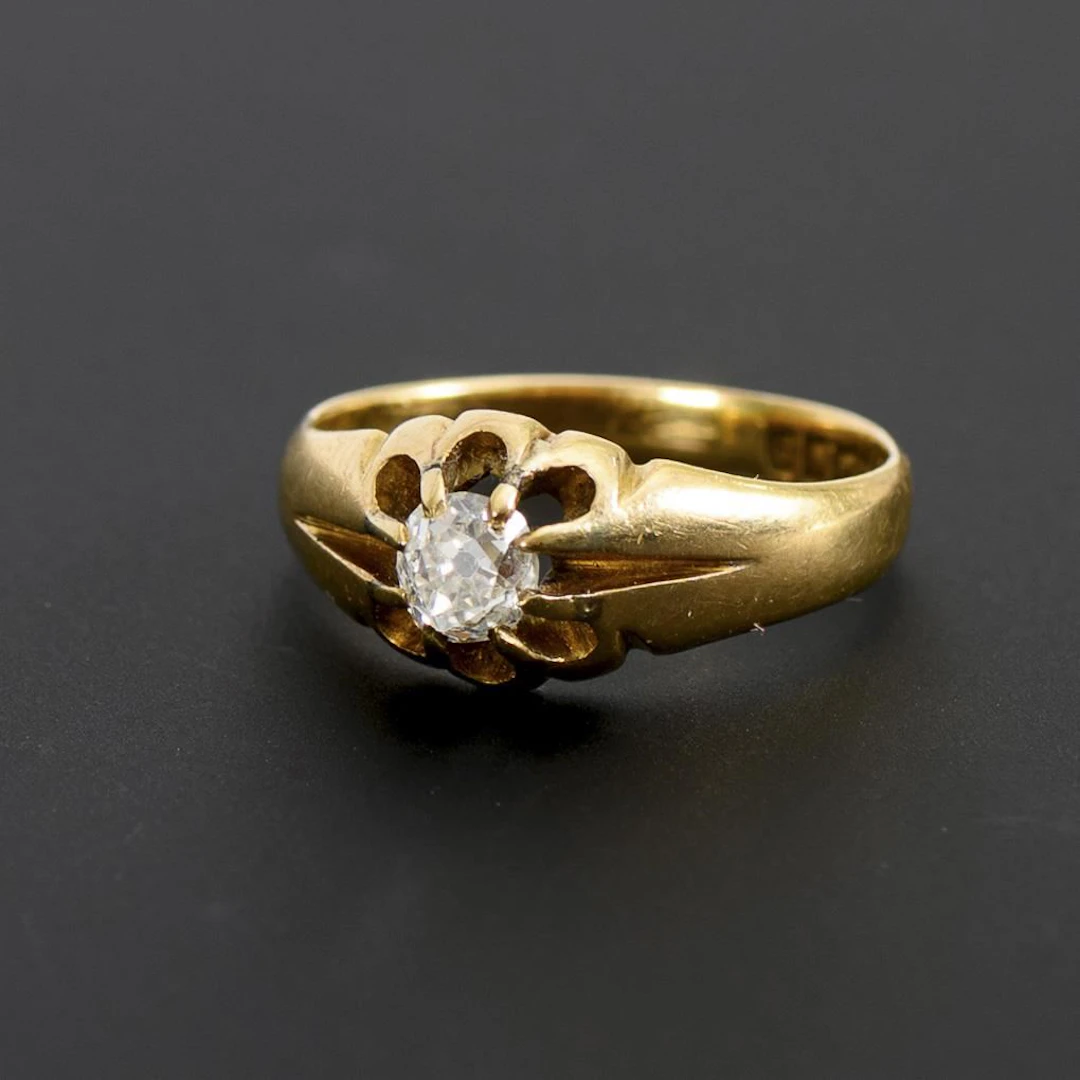 Very small ring with a large old-cut solitaire.