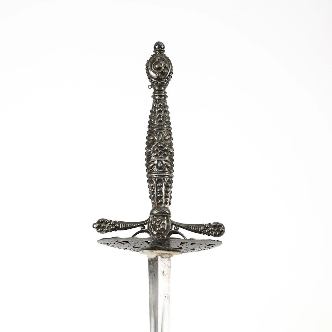Sword with a triangular blade and a white scabbard.