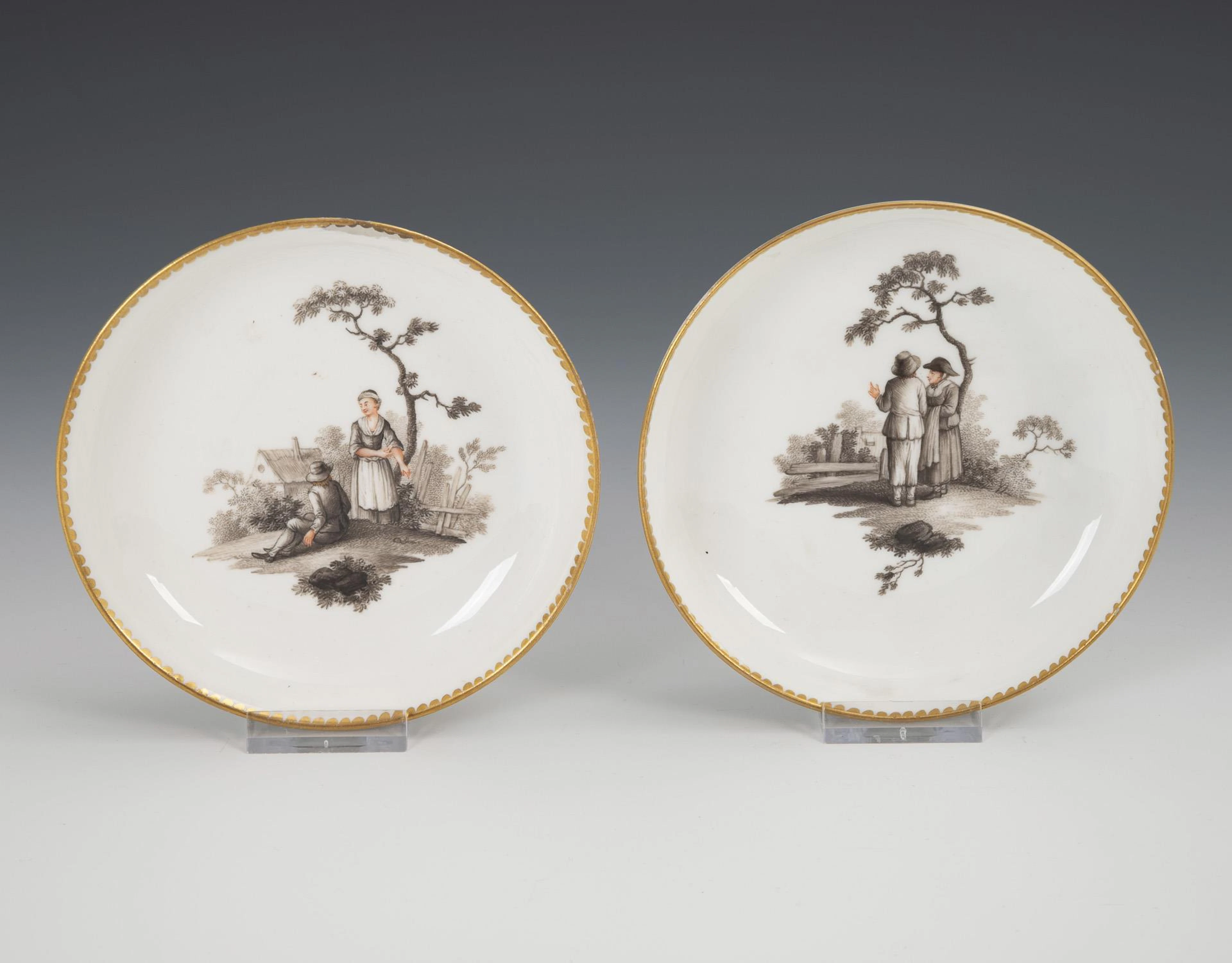 Pair of baroque saucers with peasant motifs. Meissen.