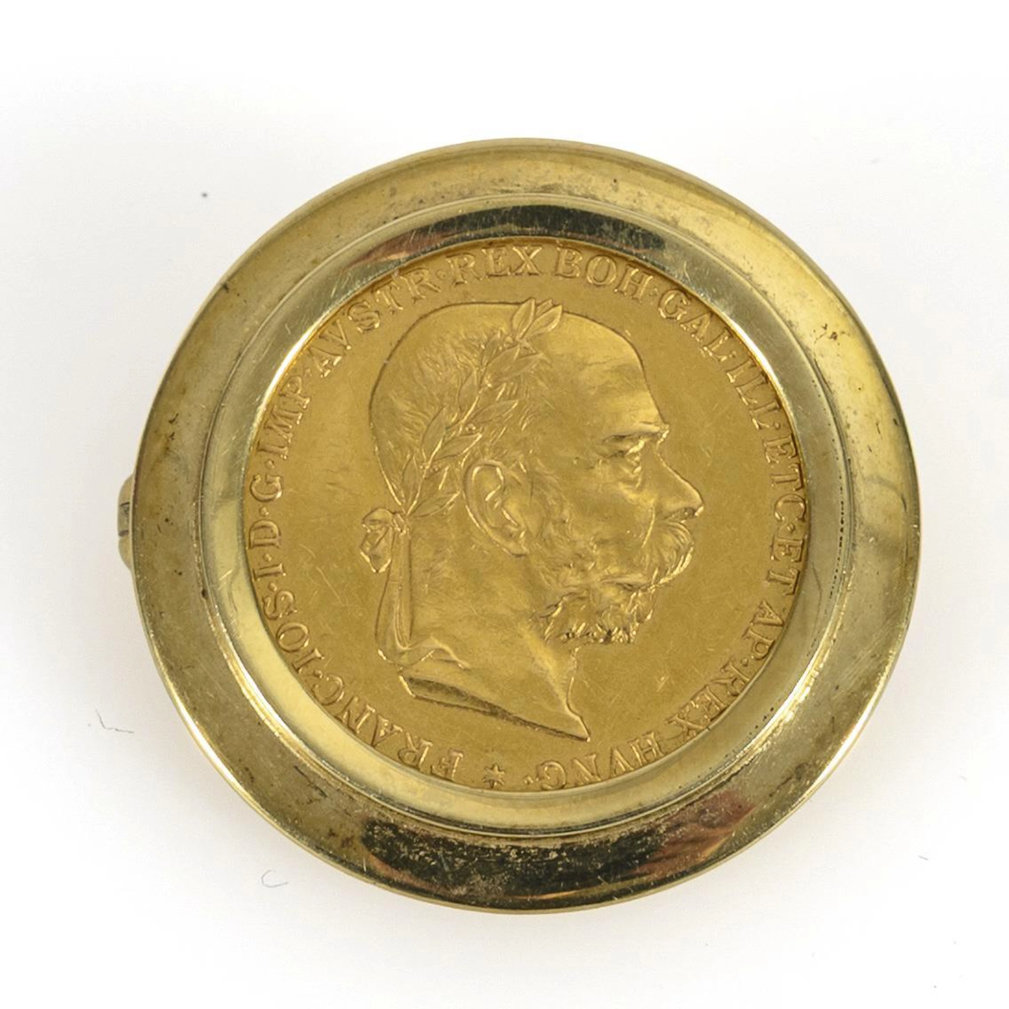 Gold coin set as a brooch.