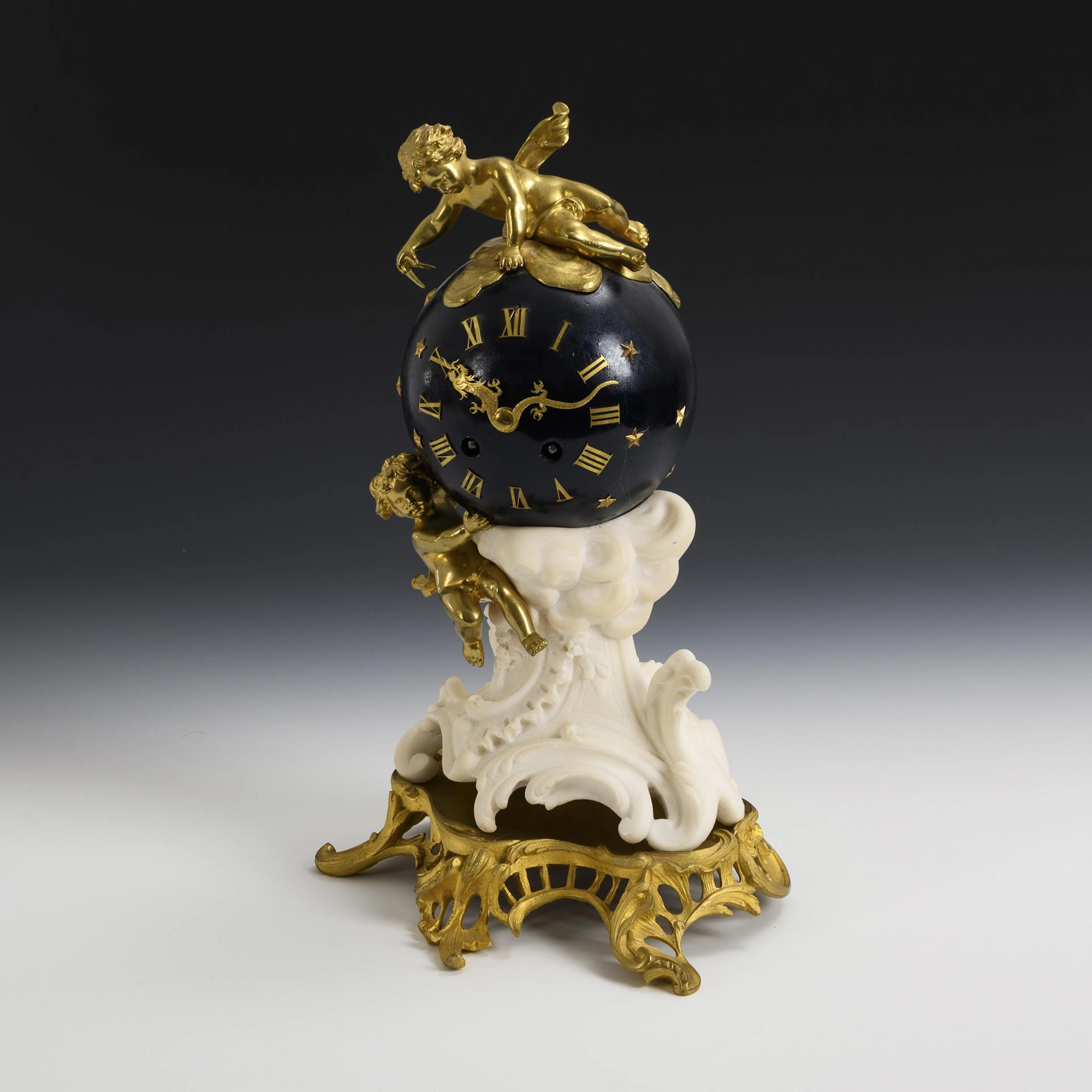French mantel clock with star ball and putti. AD. Mougin, Paris.