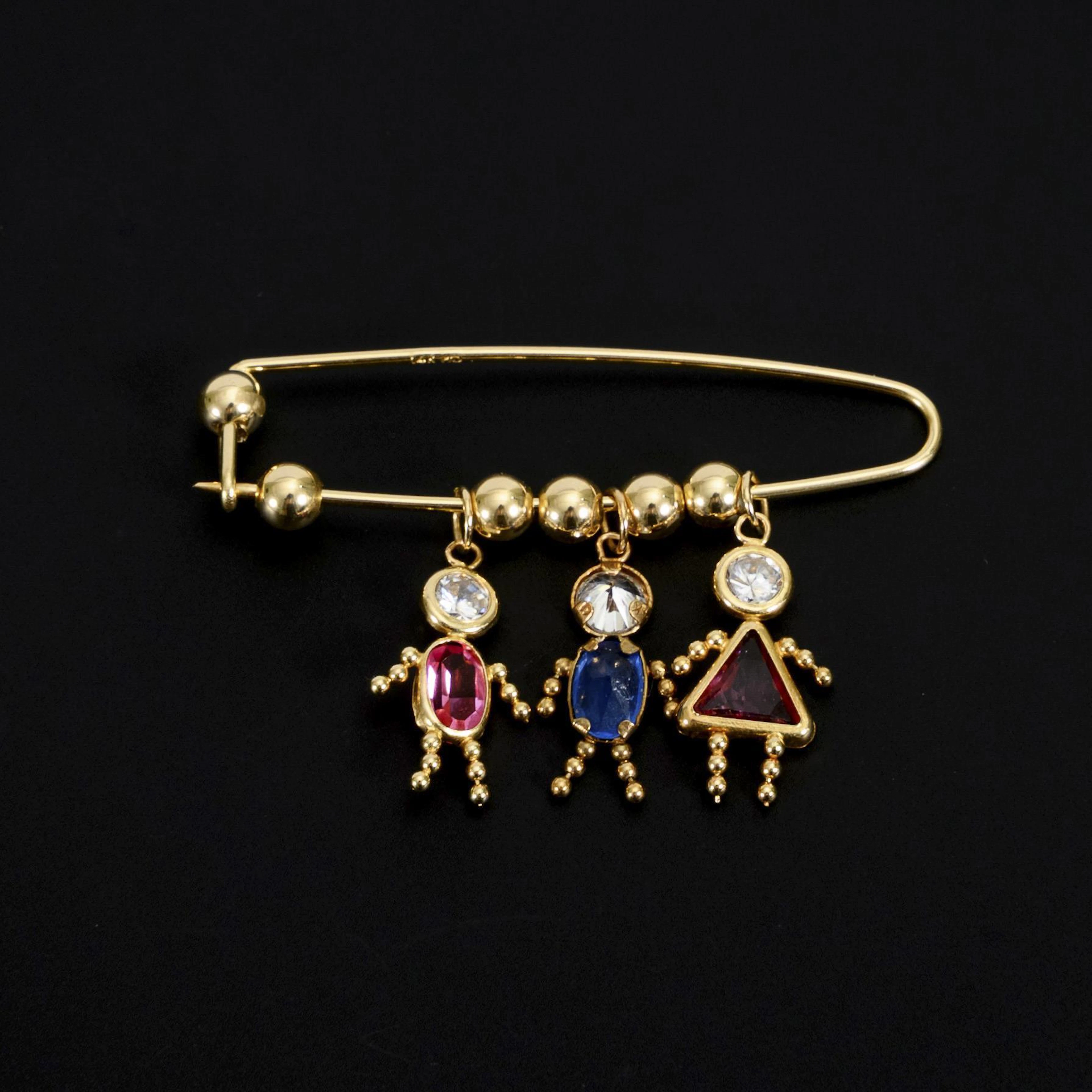 Unusual pin with figural suspensions.