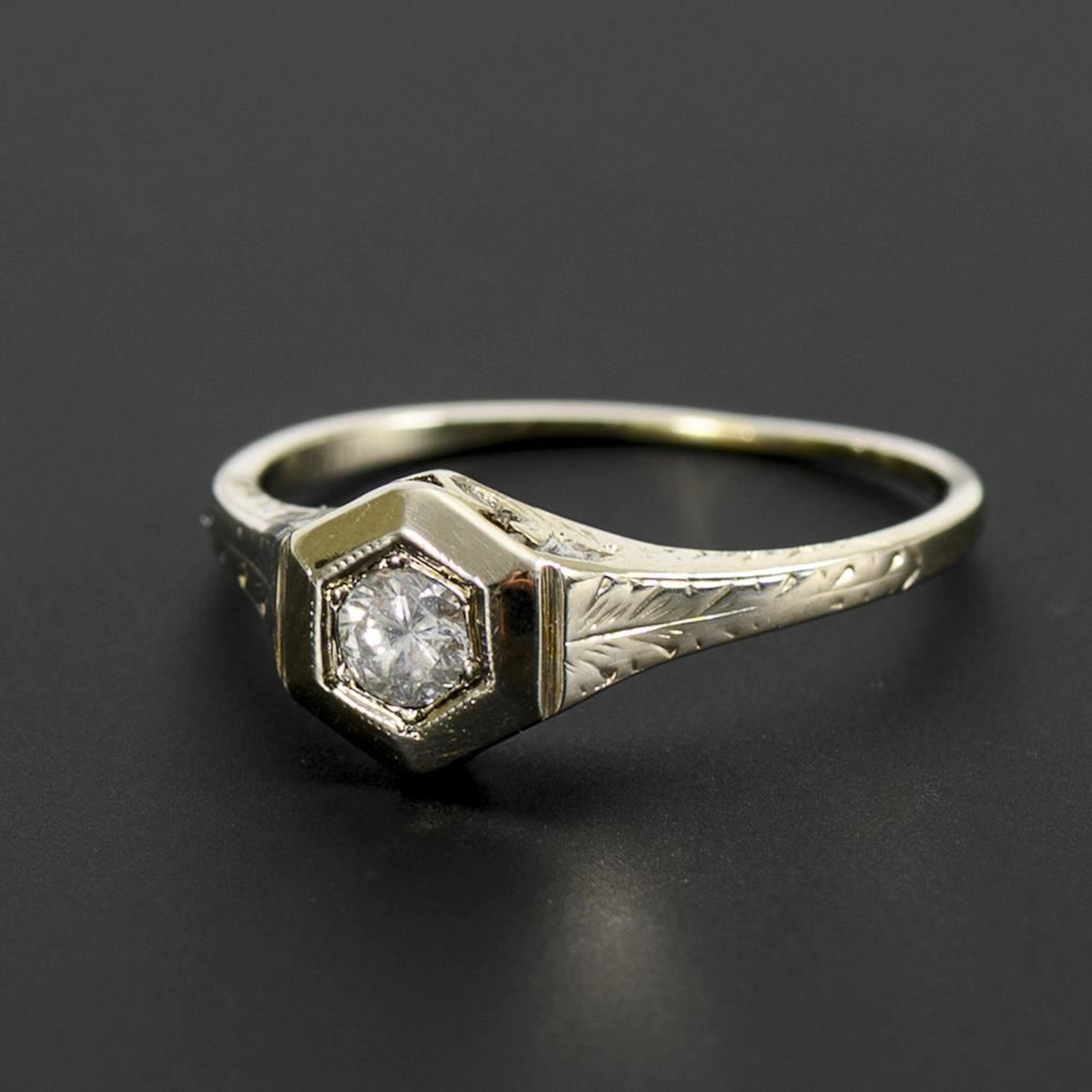 Art Deco ring with a hexagonal band and a solitaire brilliant-cut diamond.
