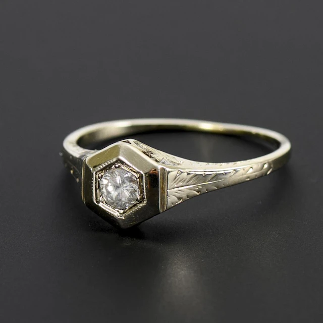 Art Deco ring with a hexagonal band and a solitaire brilliant-cut diamond.