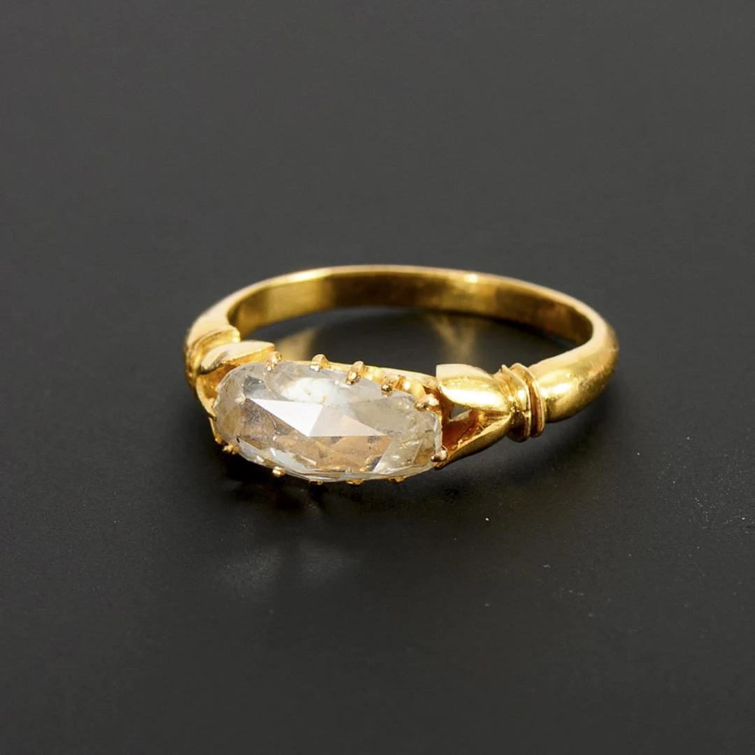 Unusual ring with a slightly teardrop-shaped diamond.
