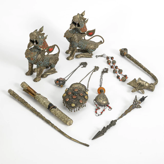 A collection of Tibetan utensils with coral and turquoise.