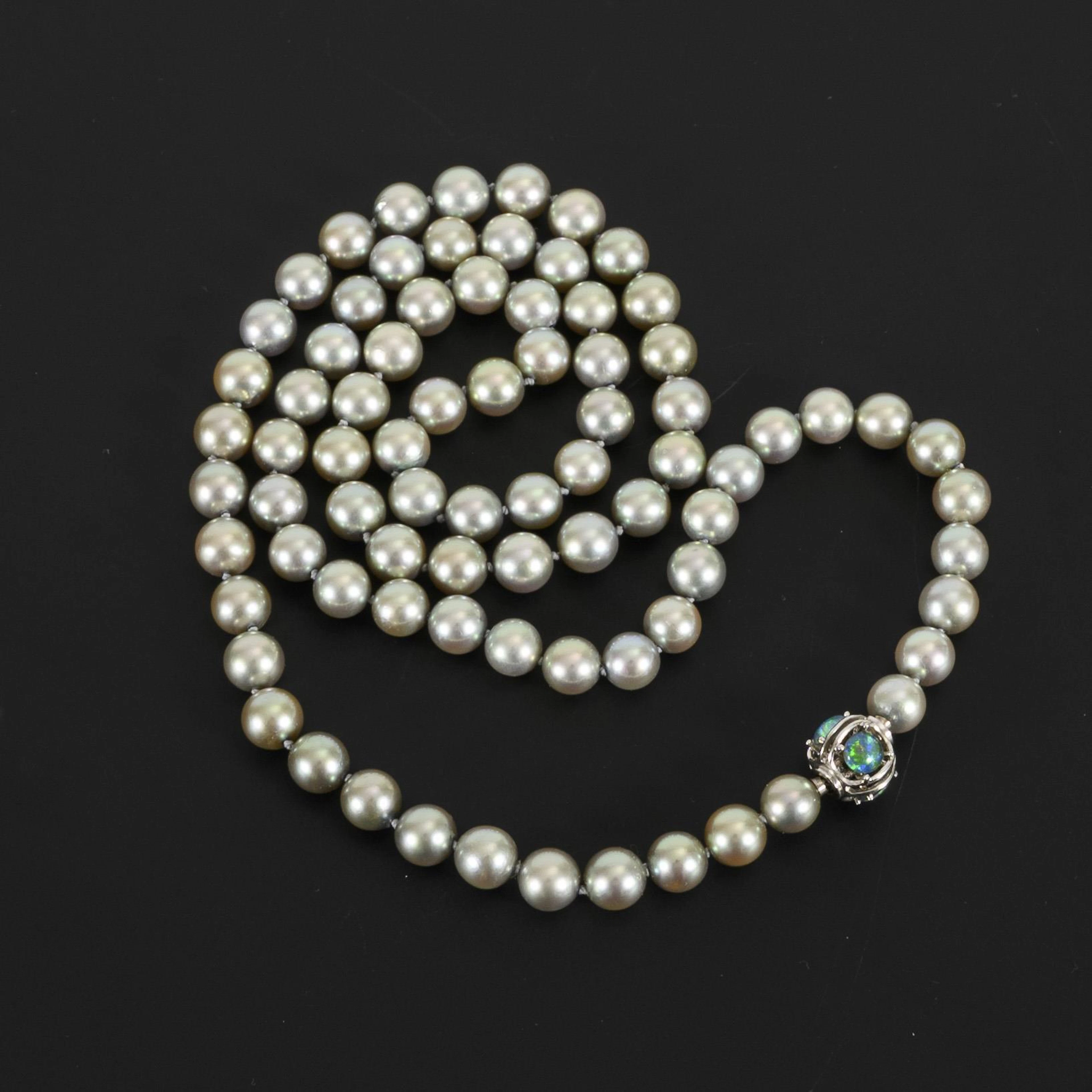 Grey pearl necklace with decorative clasp.