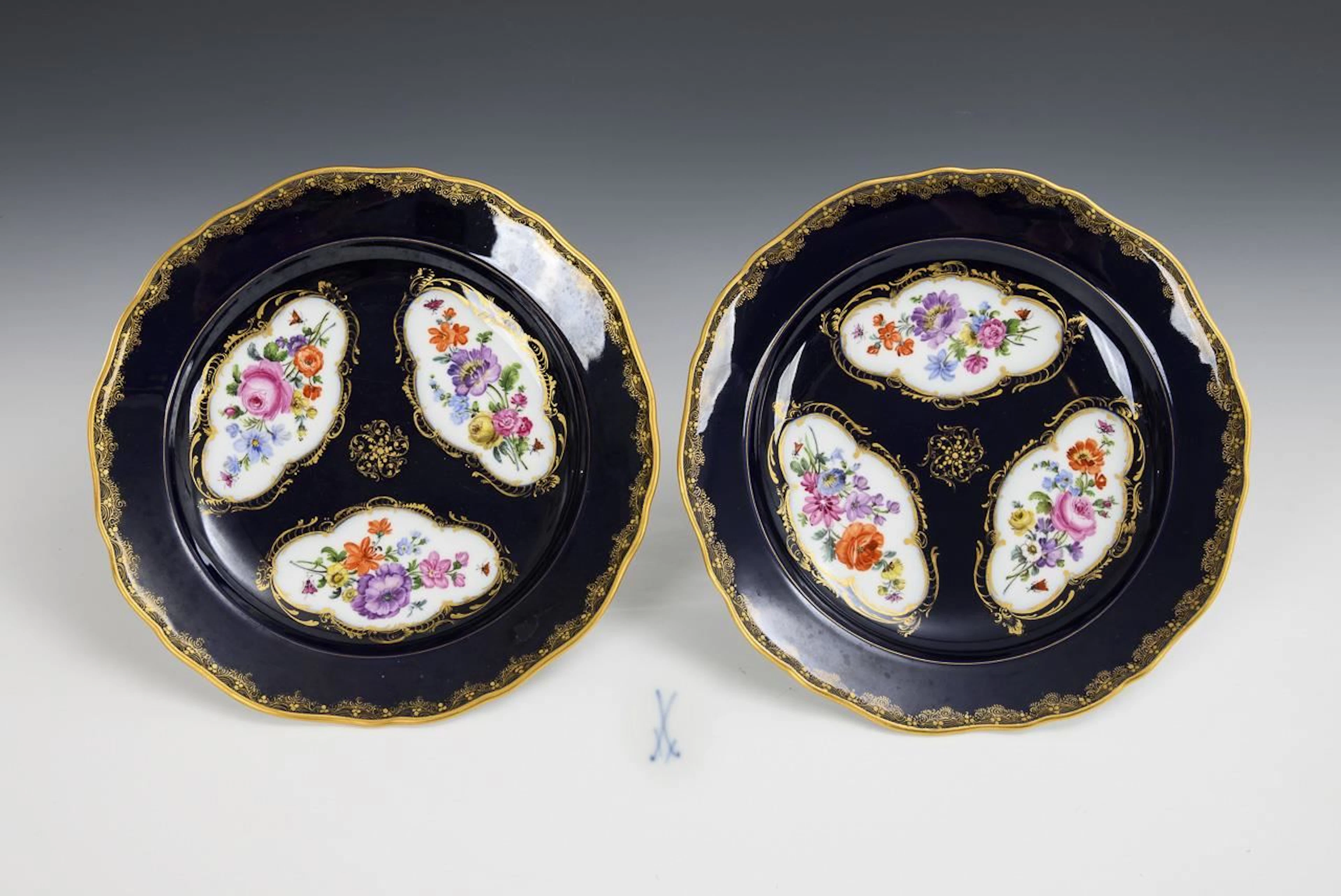 Pair of plates with cobalt ground and floral painting. Meissen.