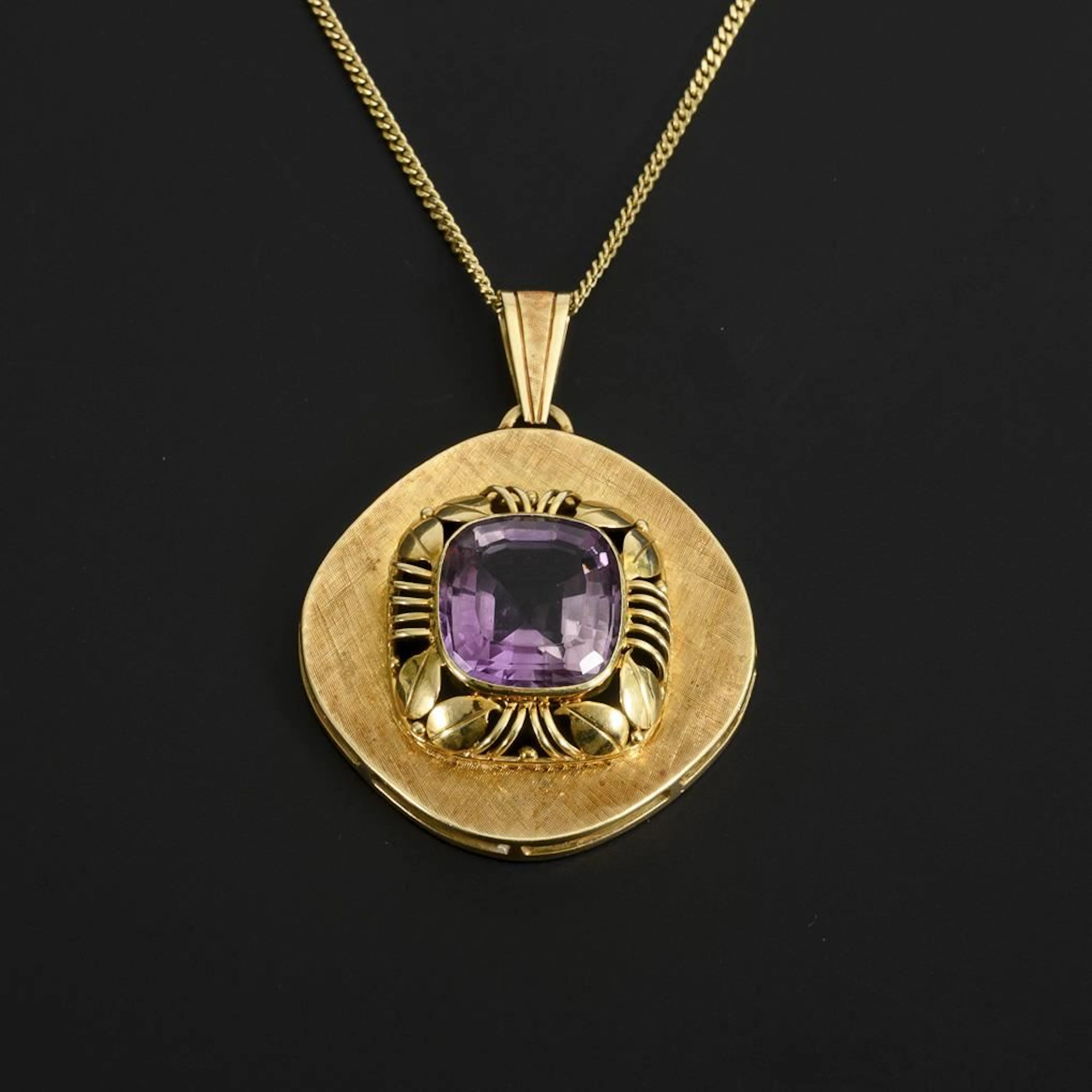 Amethyst pendant on a chain.