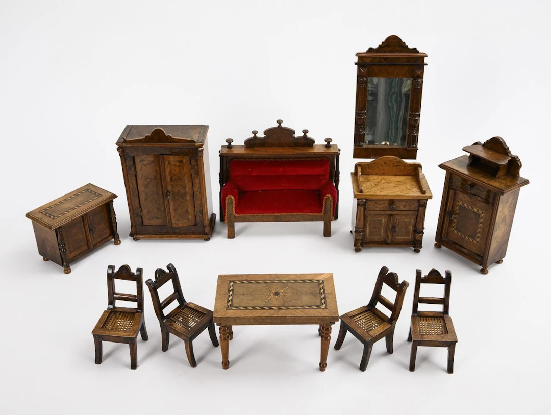 Set of doll furniture with a red sofa.