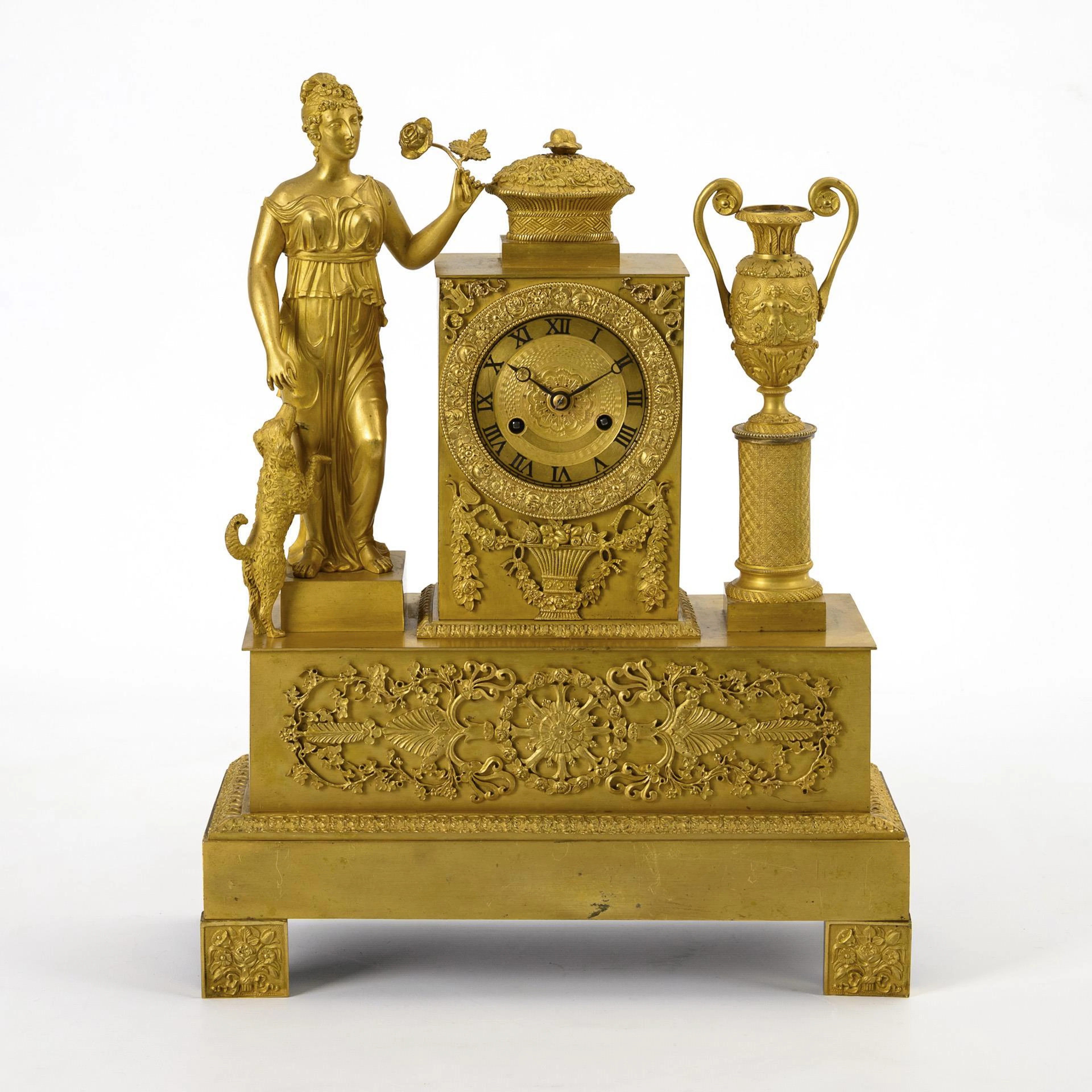 Empire bronze pendulum with female antique figure and dog.
