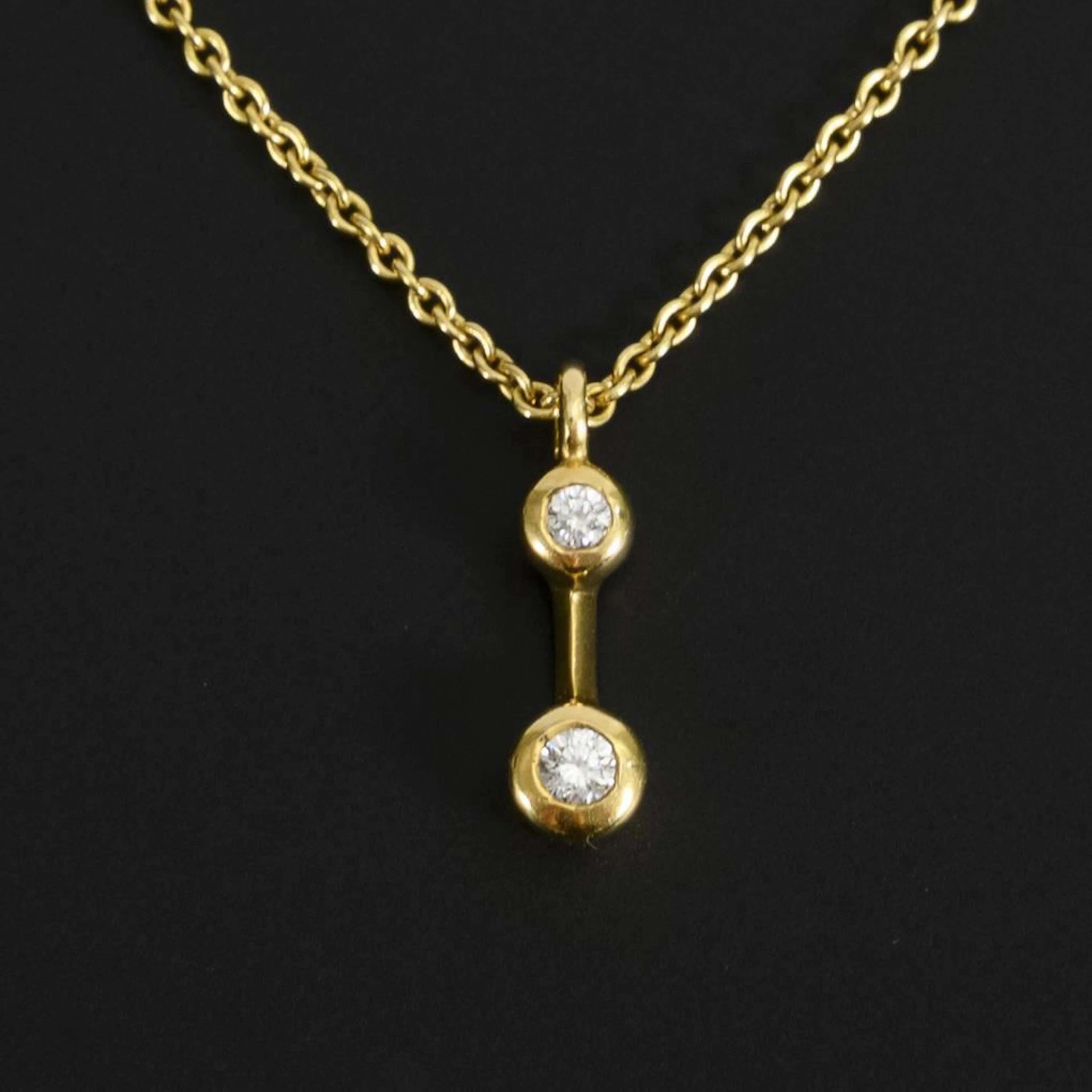 Necklace with diamond pendant.