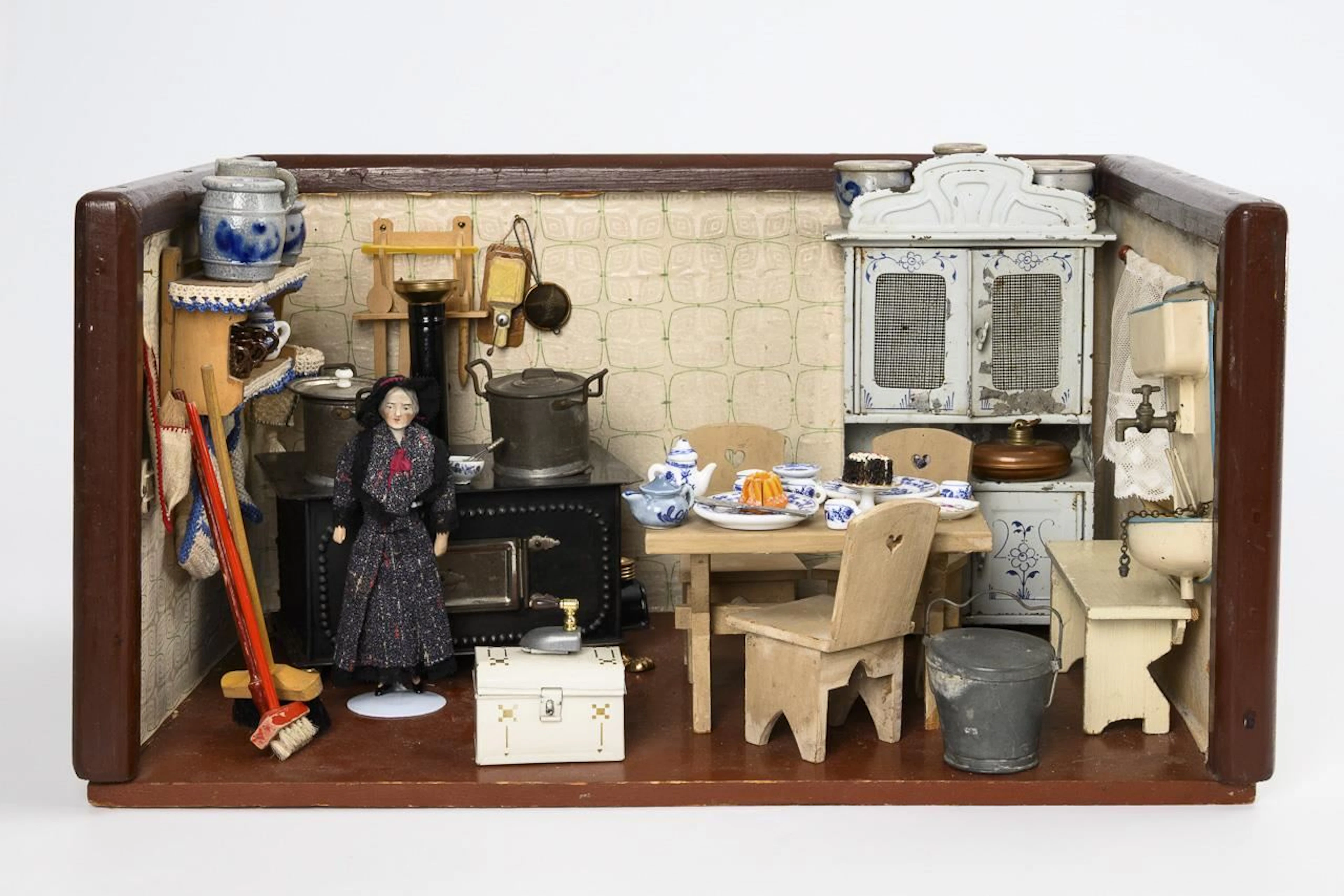 Dollhouse kitchen with tin cabinet.