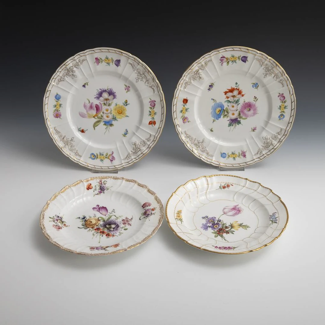 4 different plates with floral designs. KPM Berlin.
