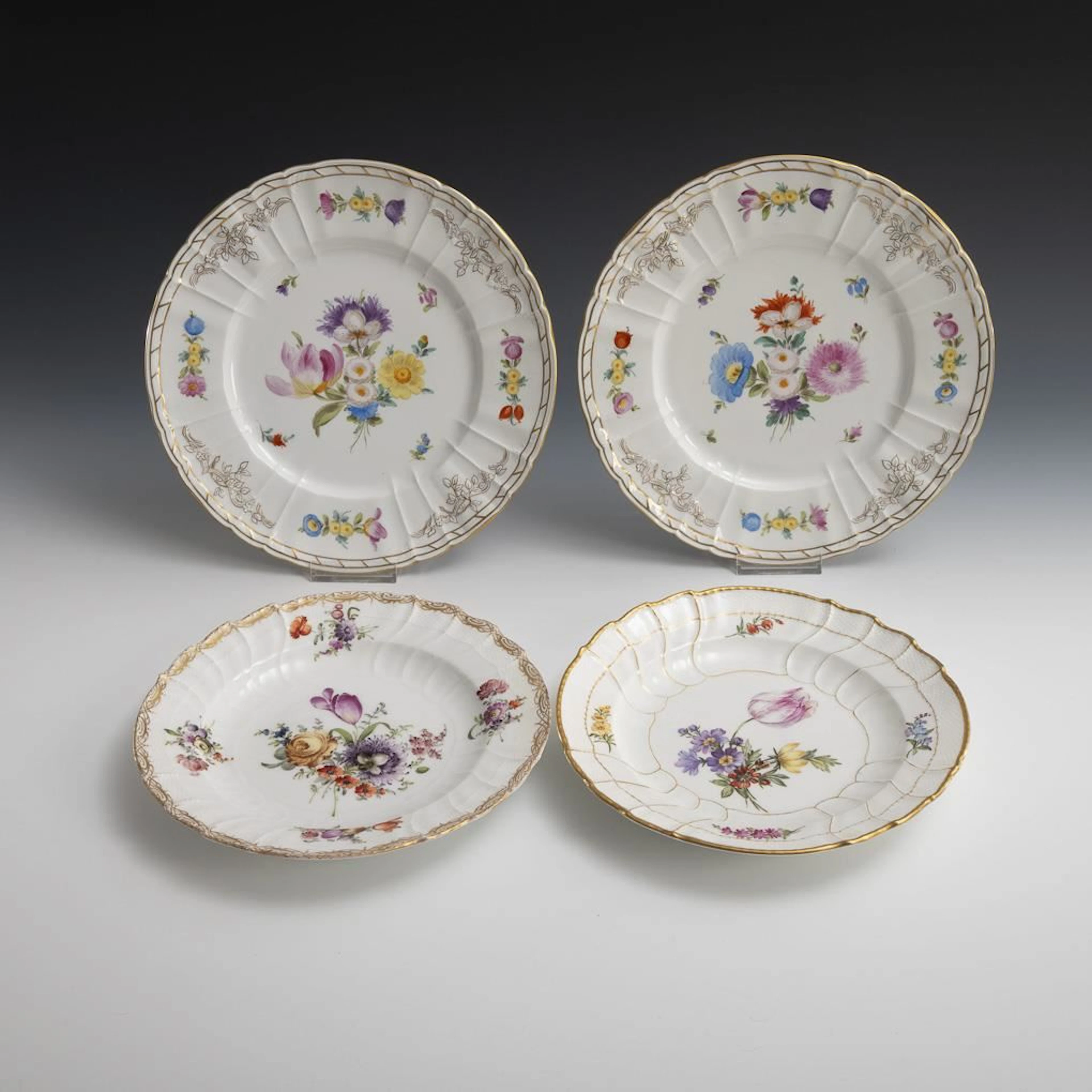 4 different plates with floral designs. KPM Berlin.