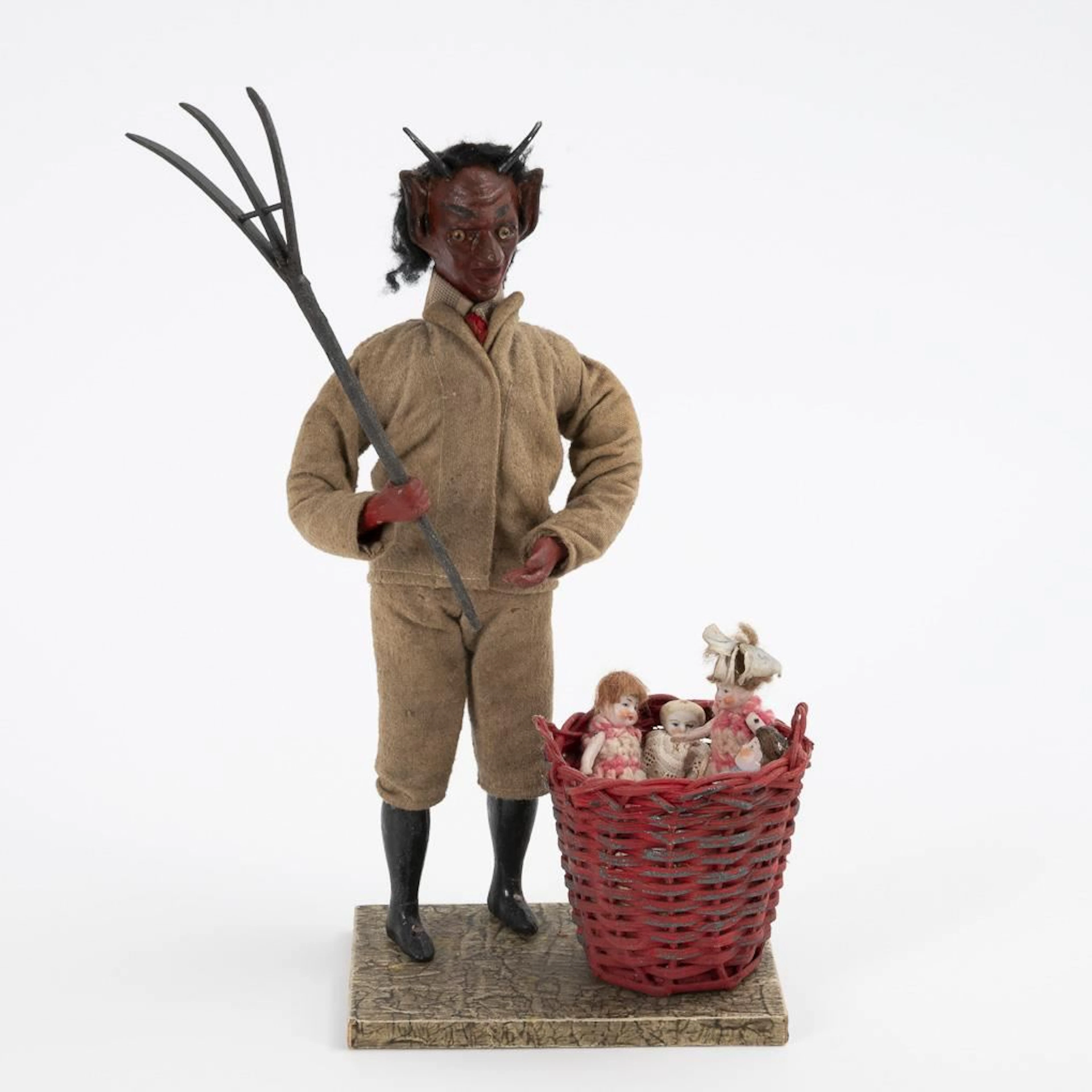 Krampus with a basket and 4 little dolls.