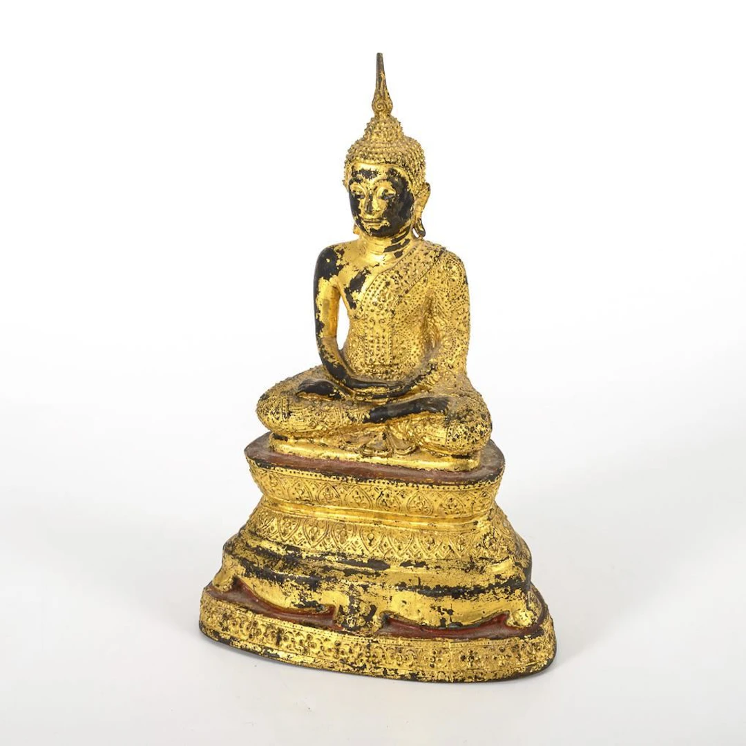 Buddha on a multi-tiered pedestal.