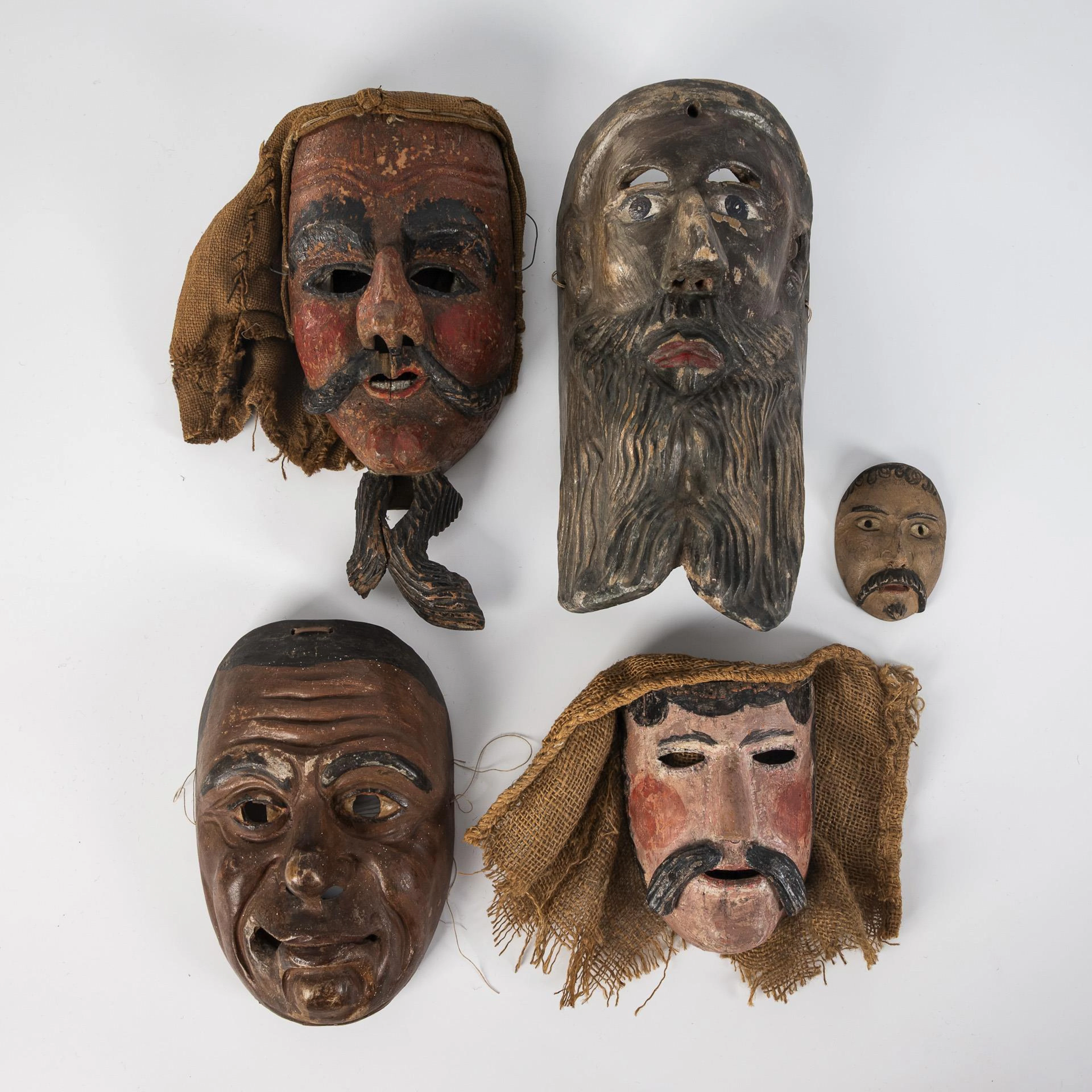 Five old carnival masks.