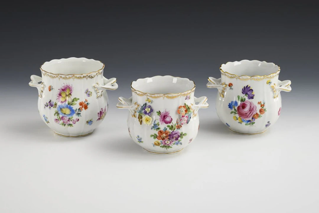 3 cachepots with floral designs. Potschappel.