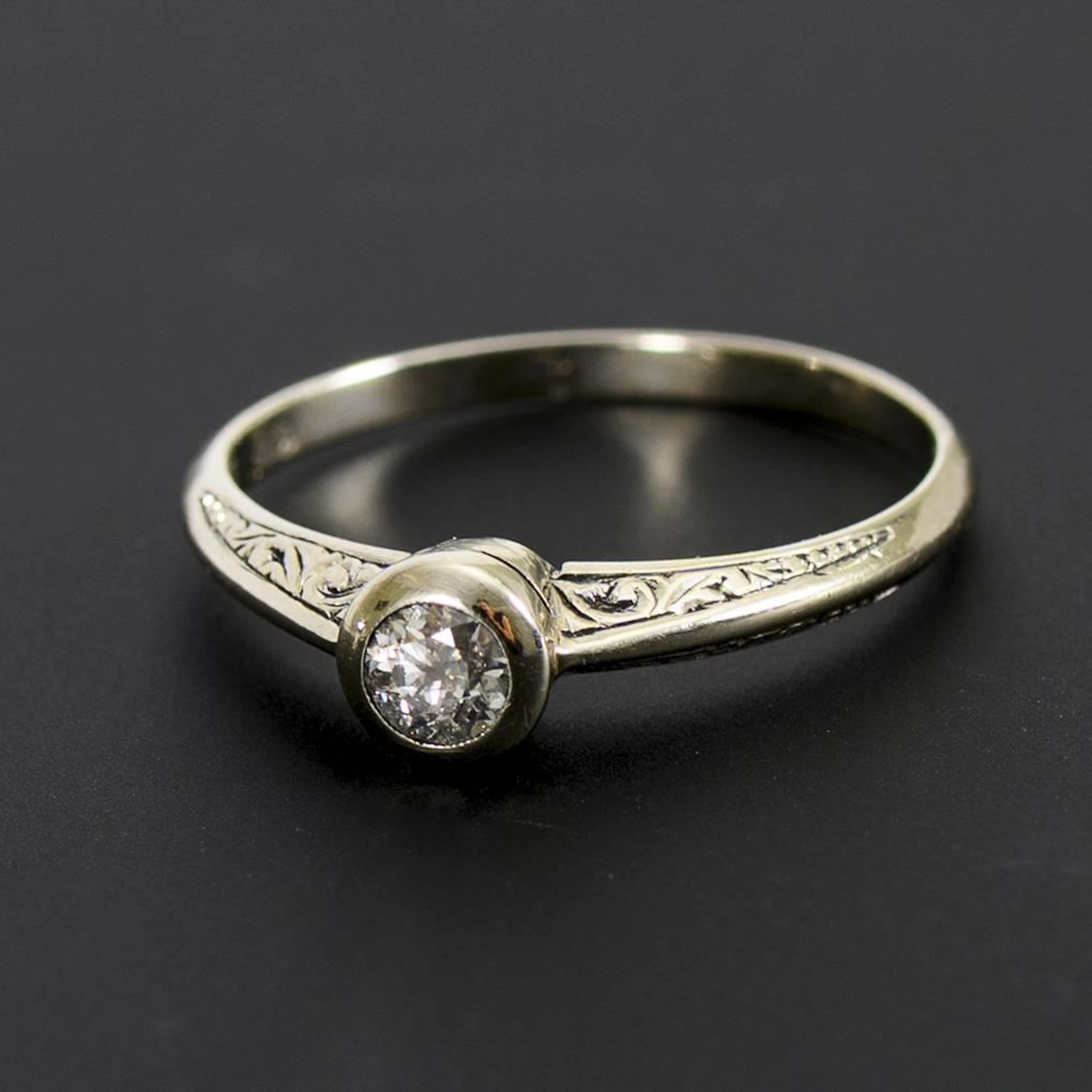 Ring with a solitaire brilliant-cut diamond.
