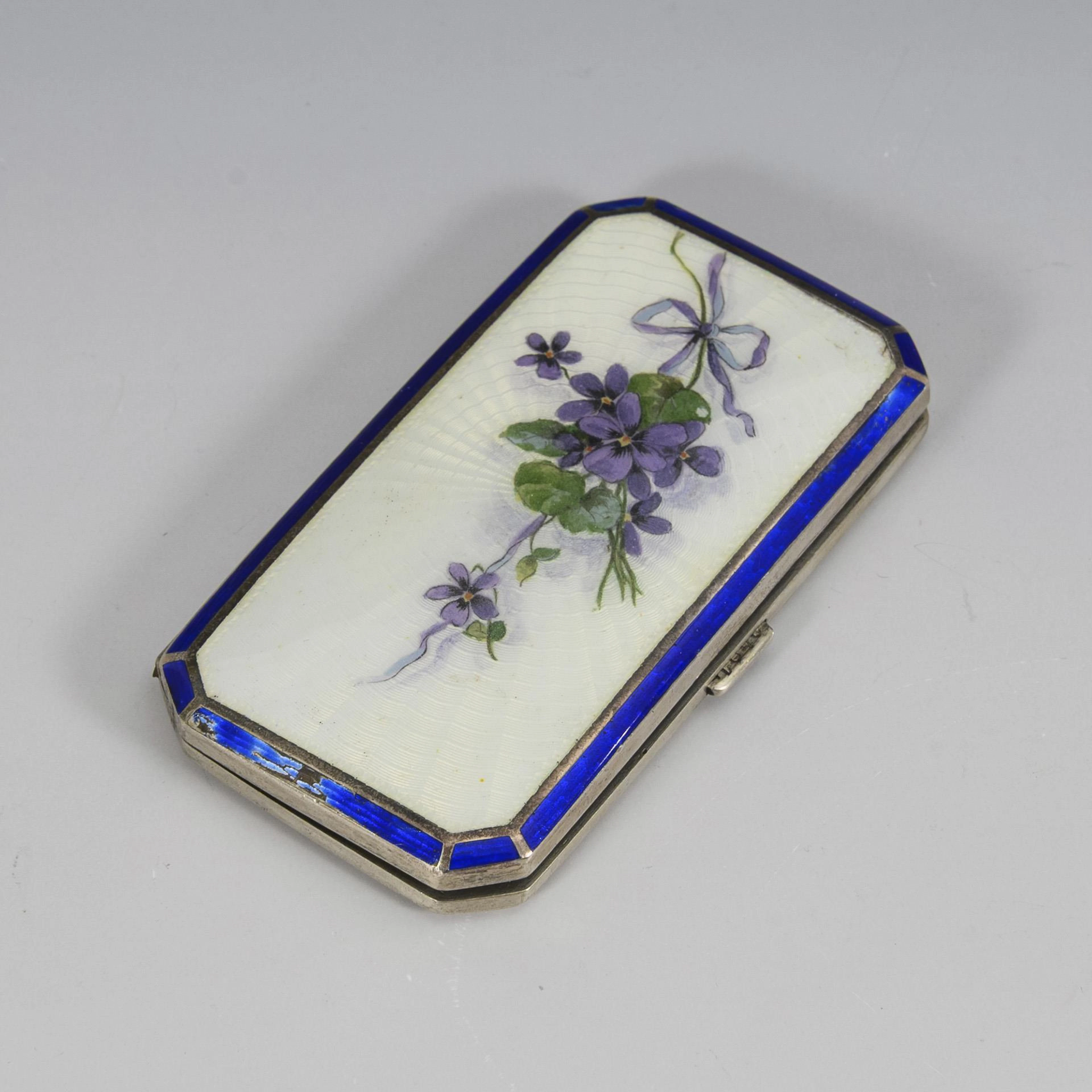 Silver case with translucent enamel.