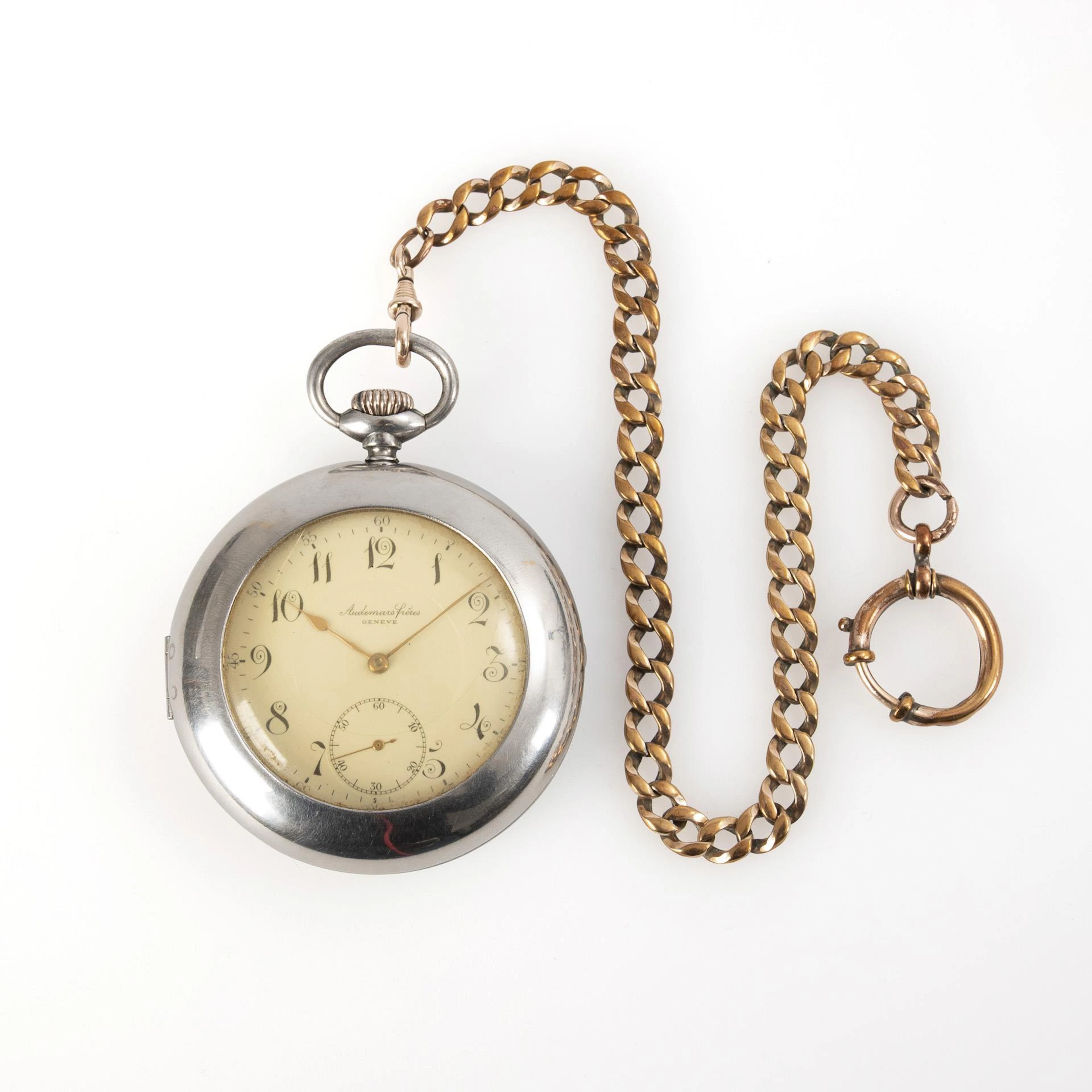 Silver pocket watch with watch jacket and watch chain. Audemars Frères, Geneva.
