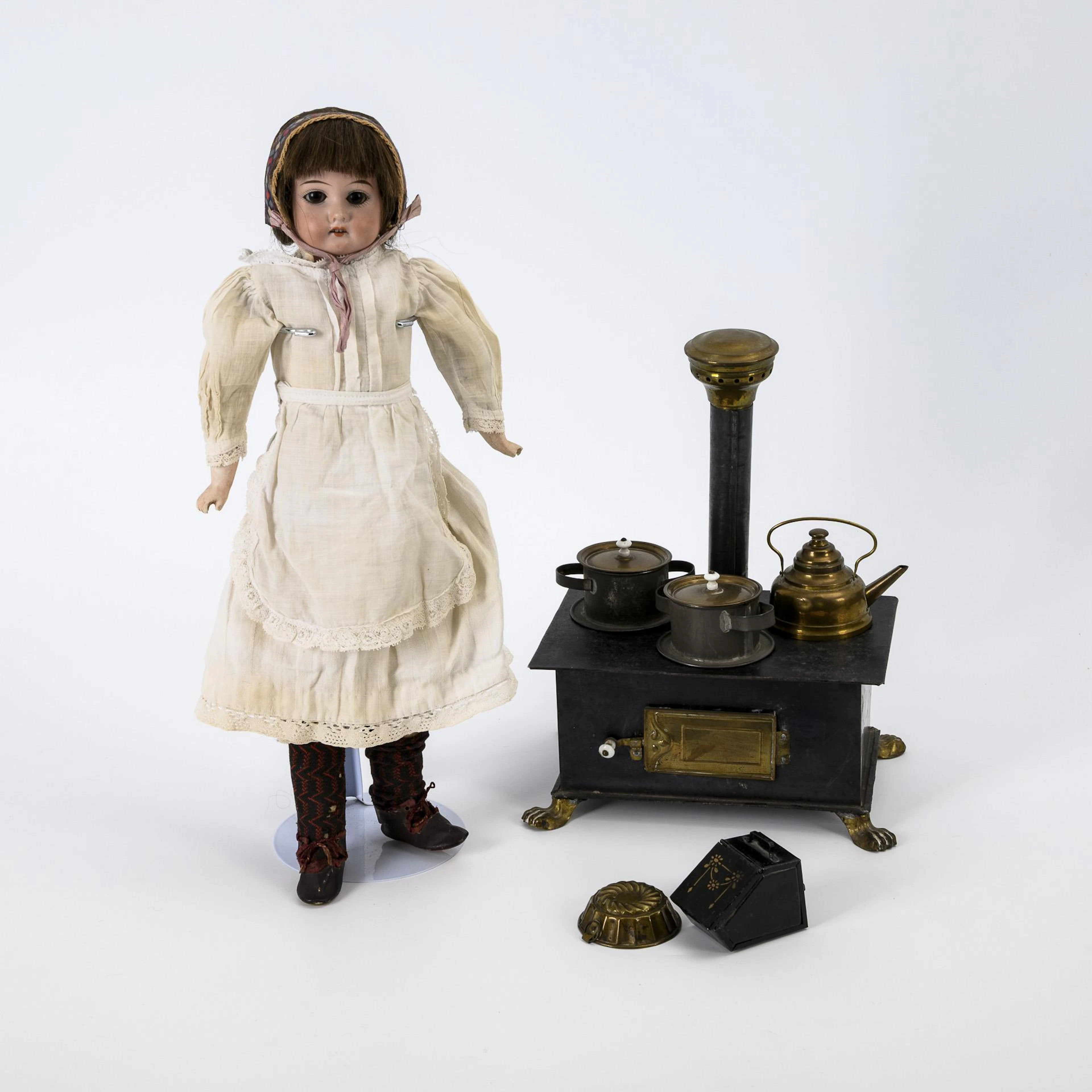 Dainty old tin stove and breasthead girl.
