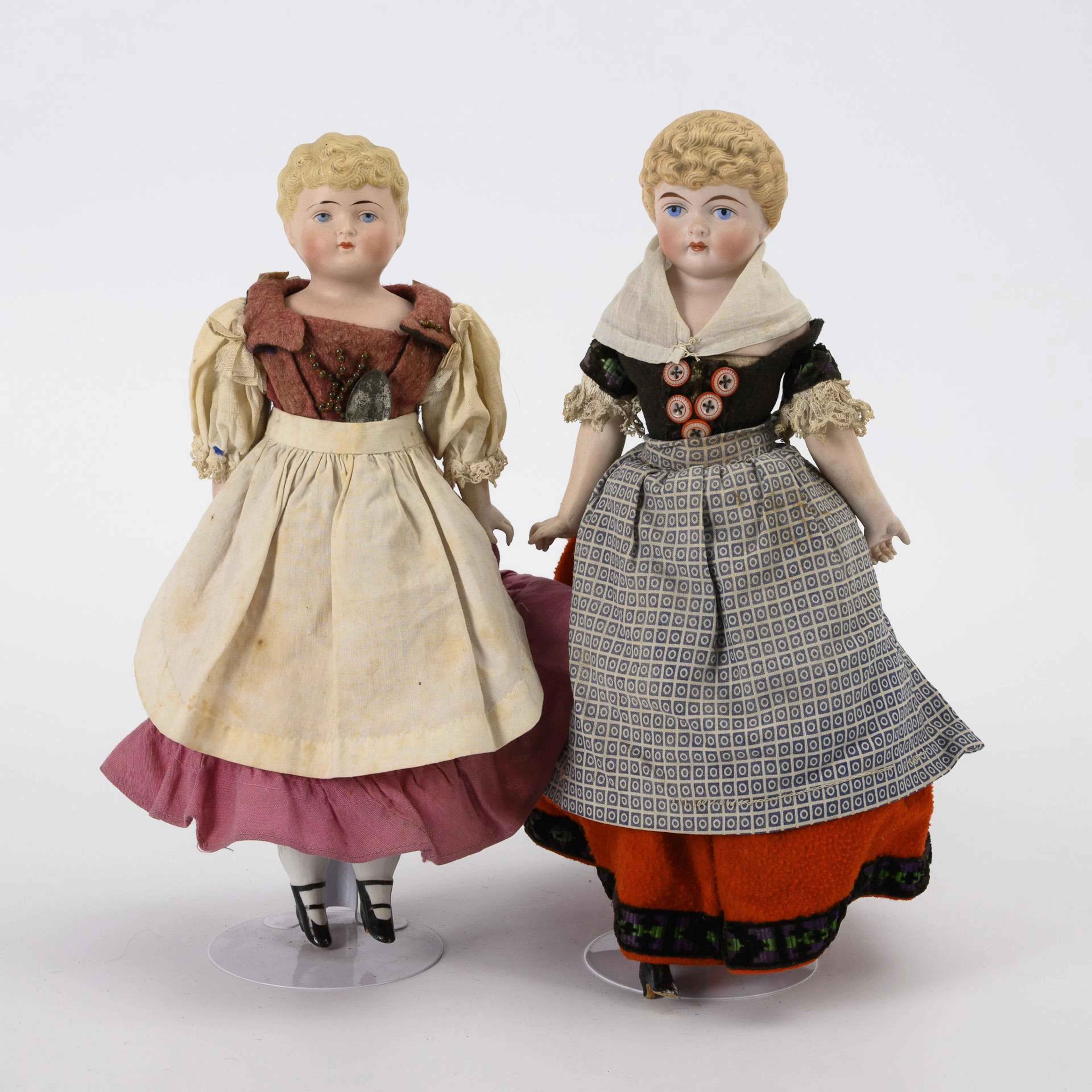 2 chest head dolls with blond hair.