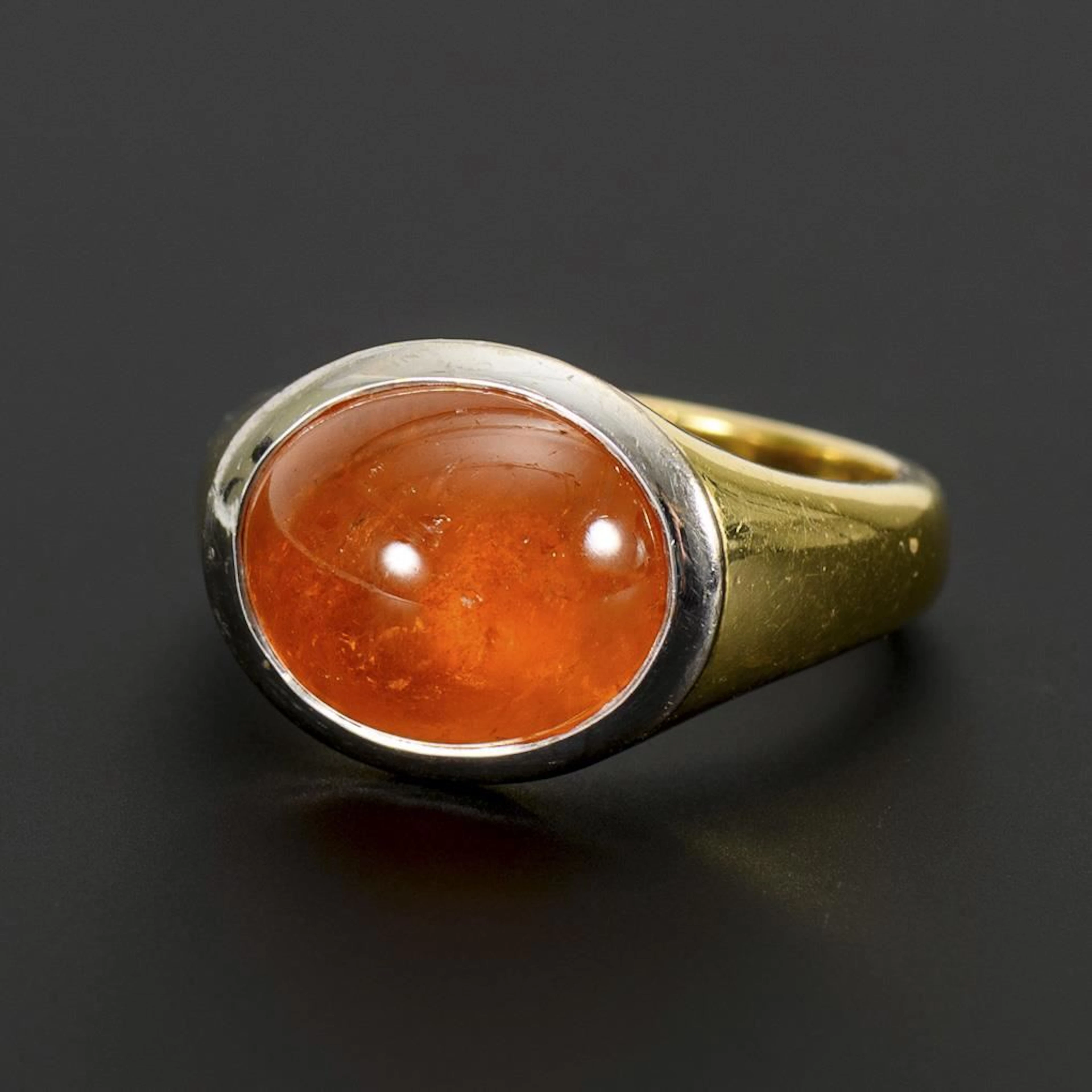 Ring with a large mandarin garnet cabochon.
