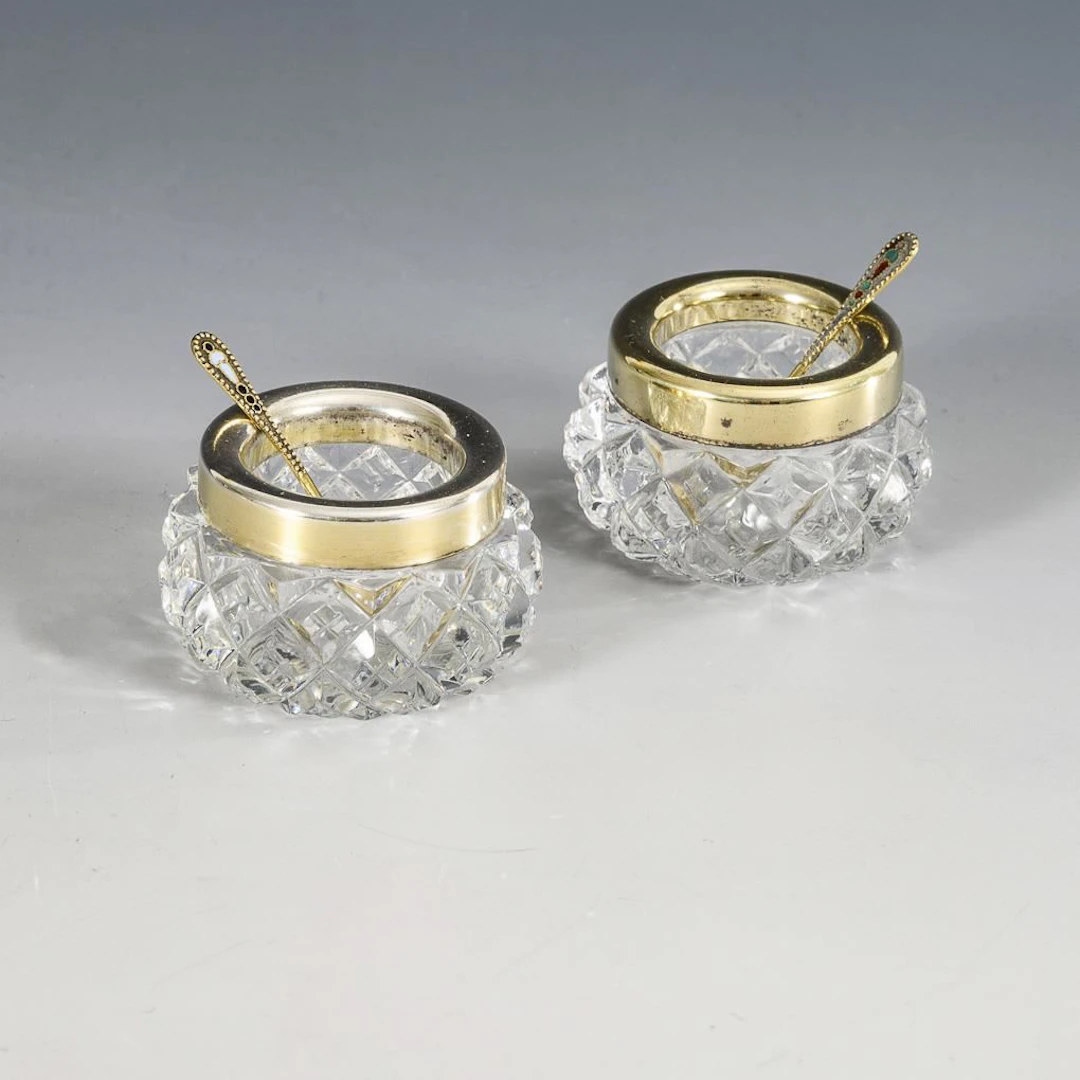 Pair of Russian salt shakers with small spoons.