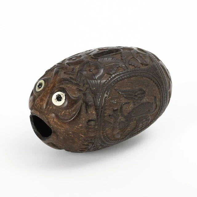 Carved coconut money box.