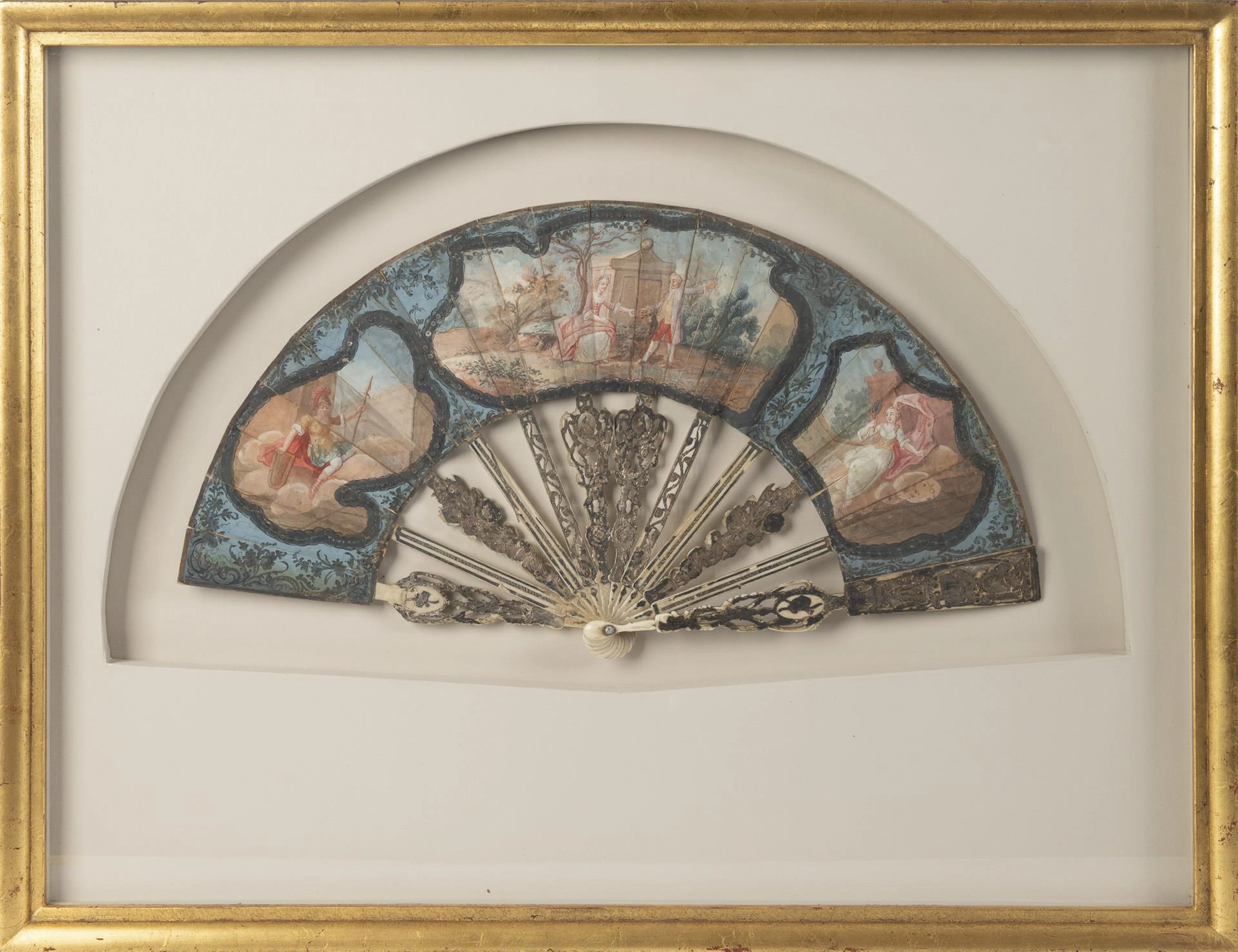 Painted baroque fan in frame.