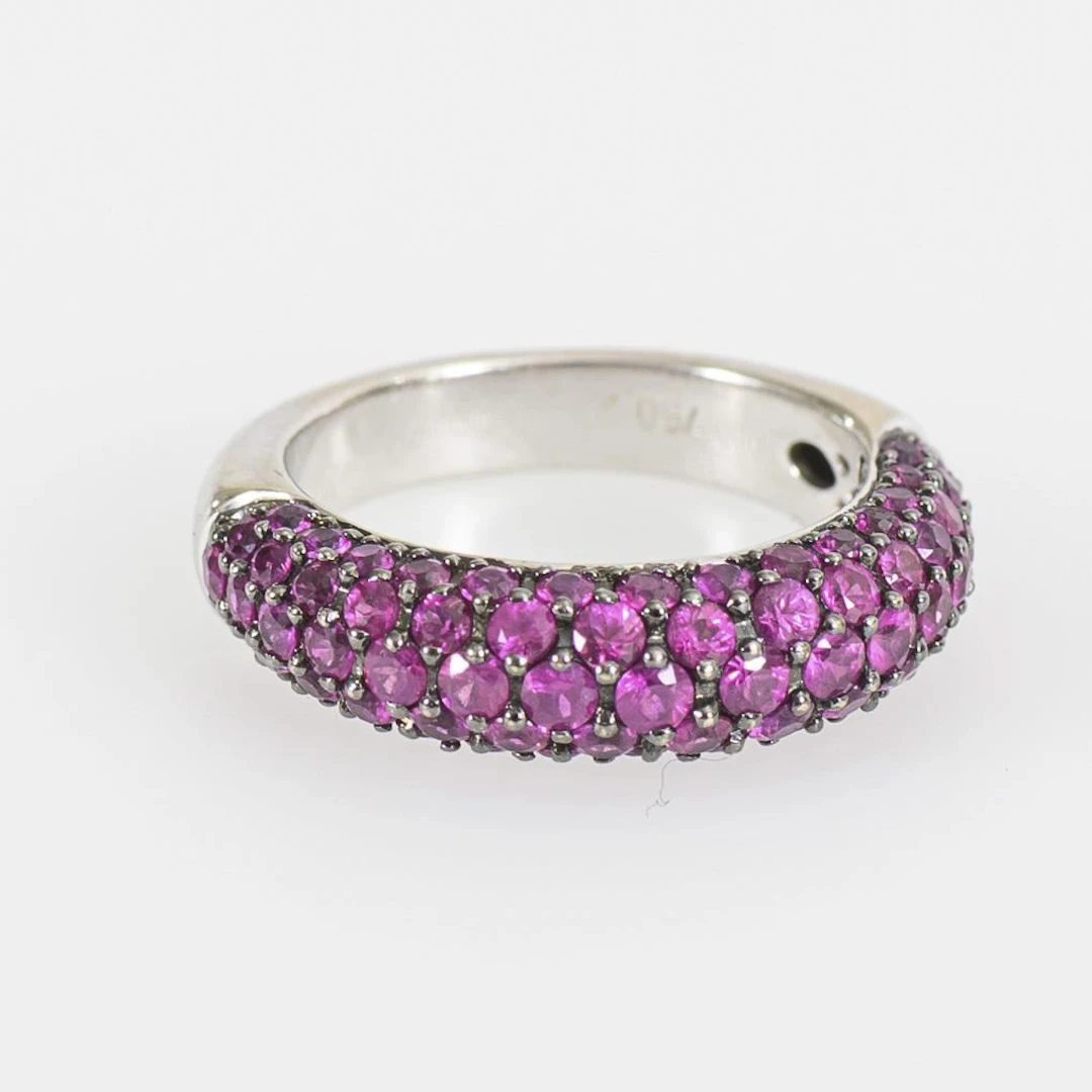 Ring with pavé-set red gemstones, likely rubies.
