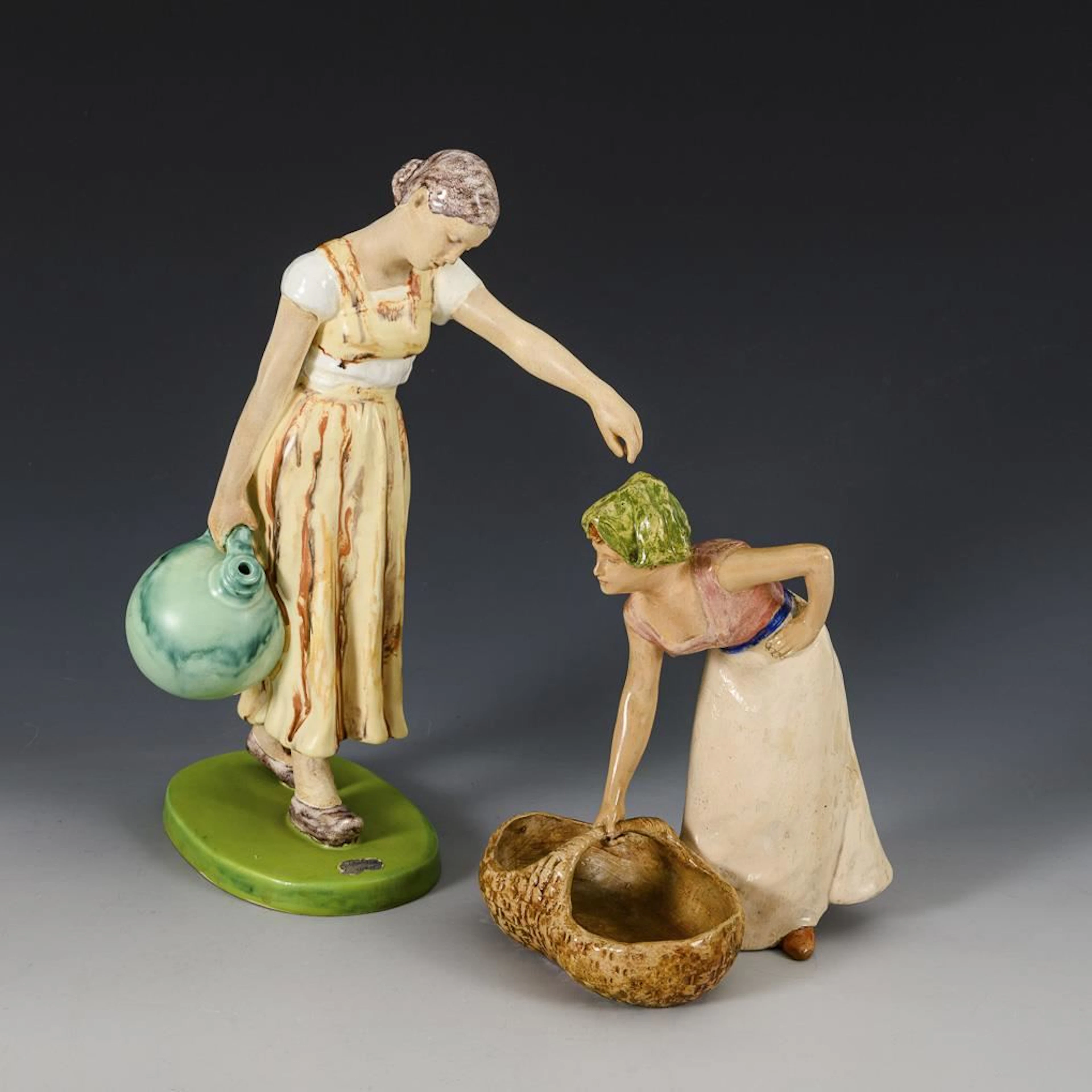 2 figurines: "Dutch Woman with a Basket" and "Woman Carrying a Jug".