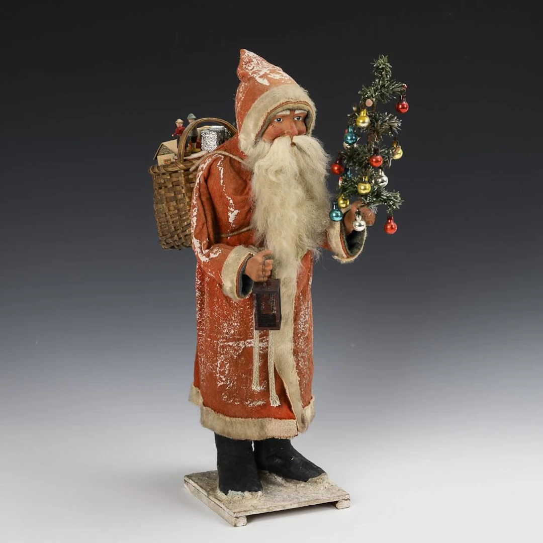 Large Santa Claus with a decorated little tree and a lantern.