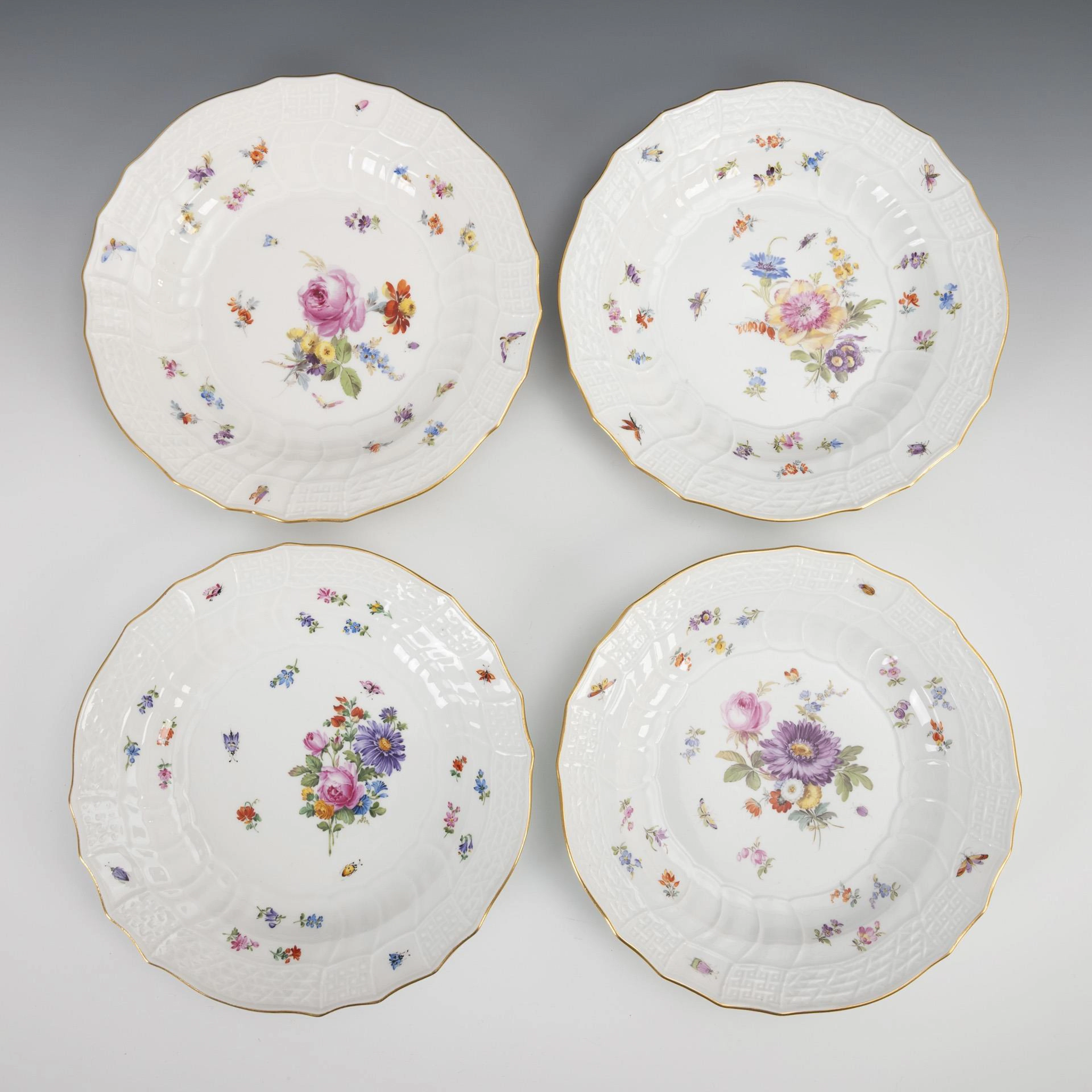 4 plates with scattered flowers and insect painting. Meissen.