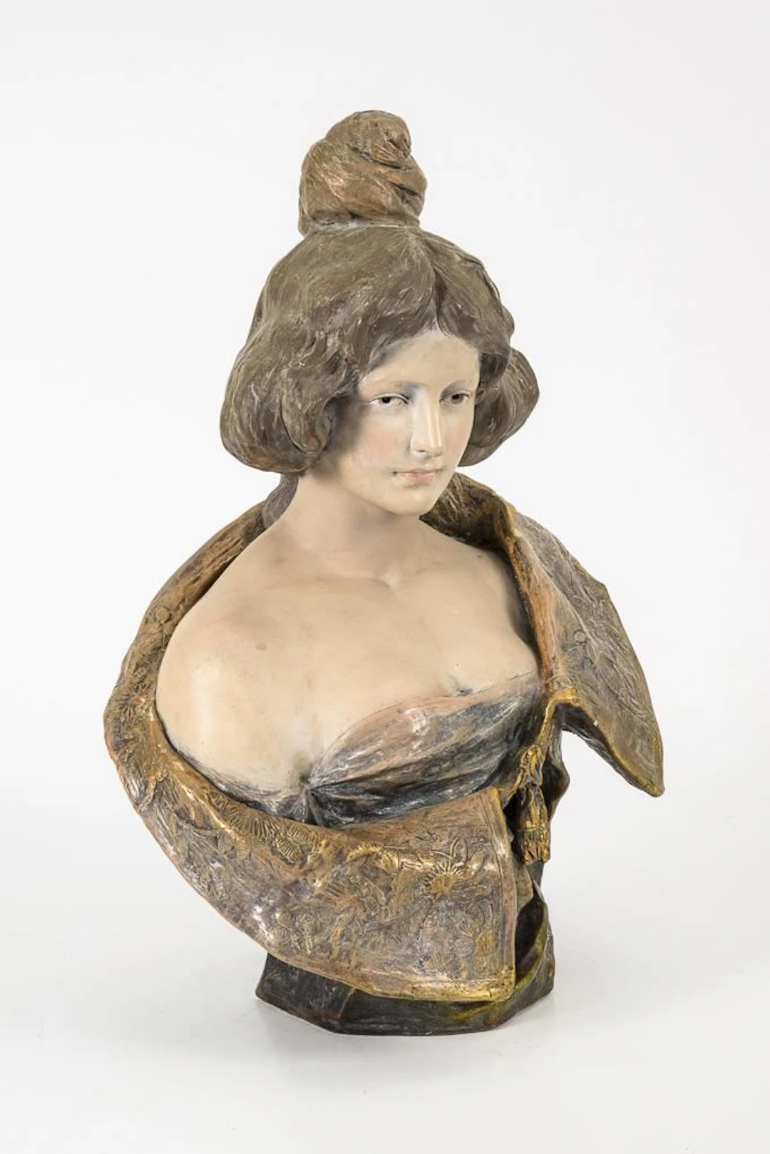 Art Nouveau bust of a woman with an updo.