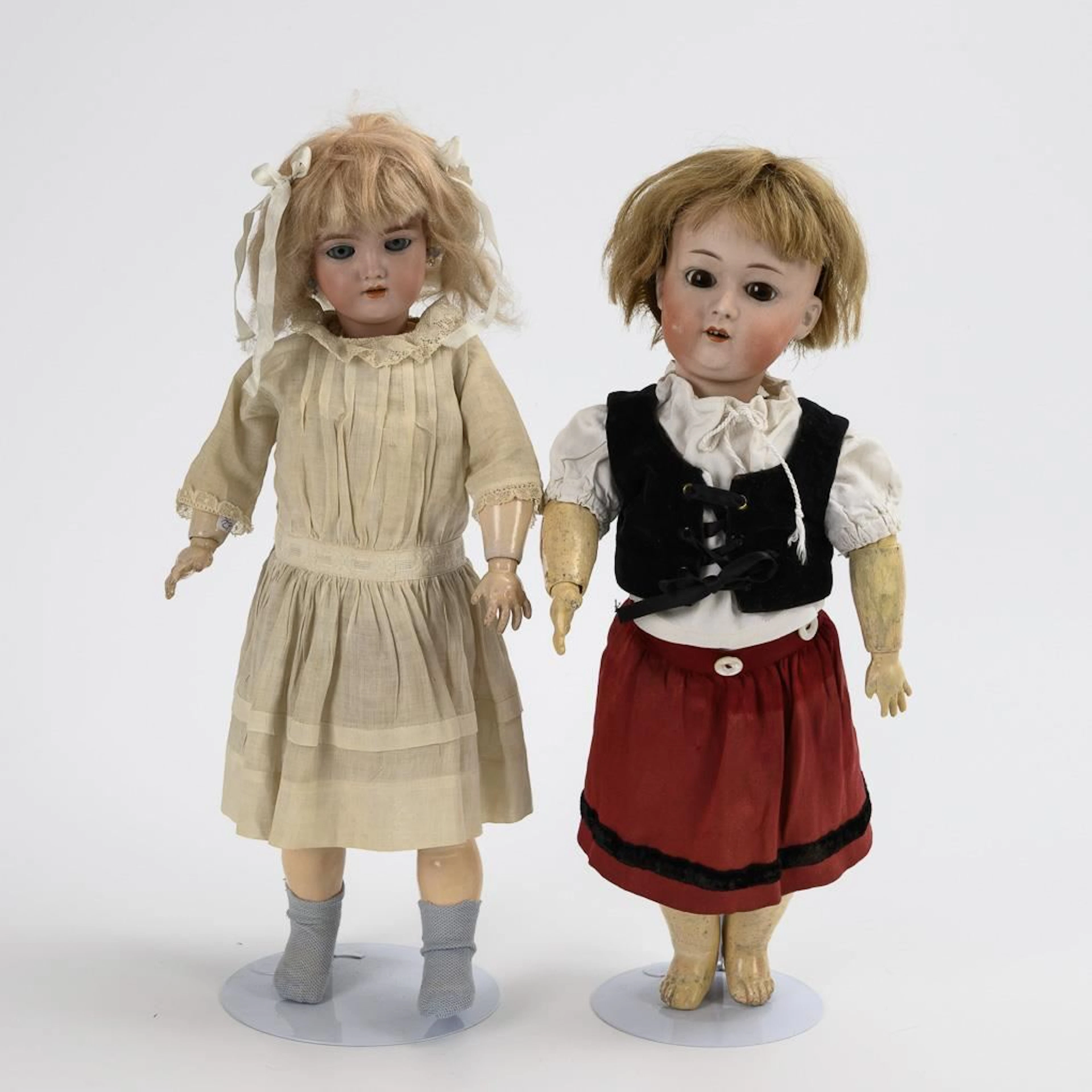2 blonde porcelain-headed dolls.