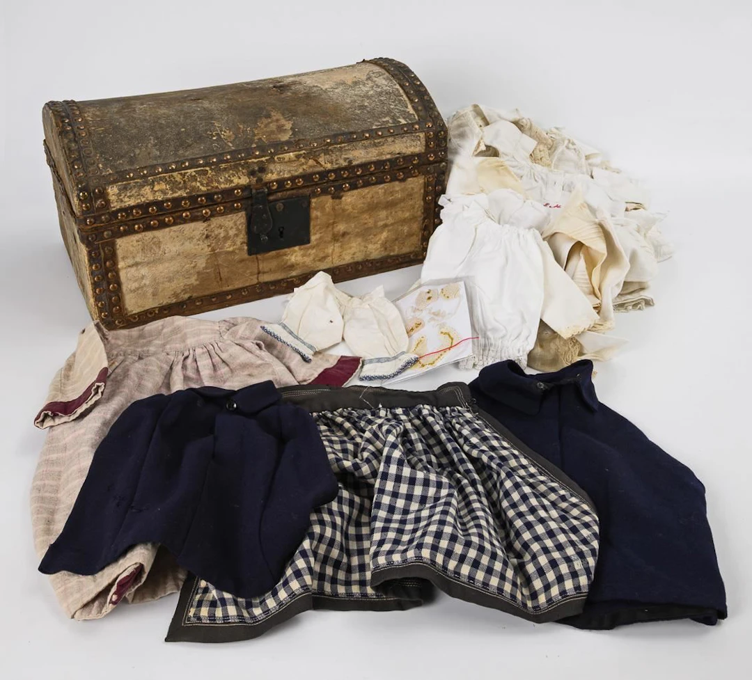 Antique trousseau with doll clothes.