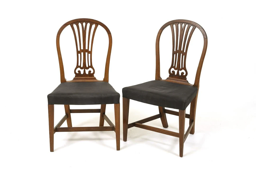 2 English upholstered chairs. In the style of George Hepplewhite.