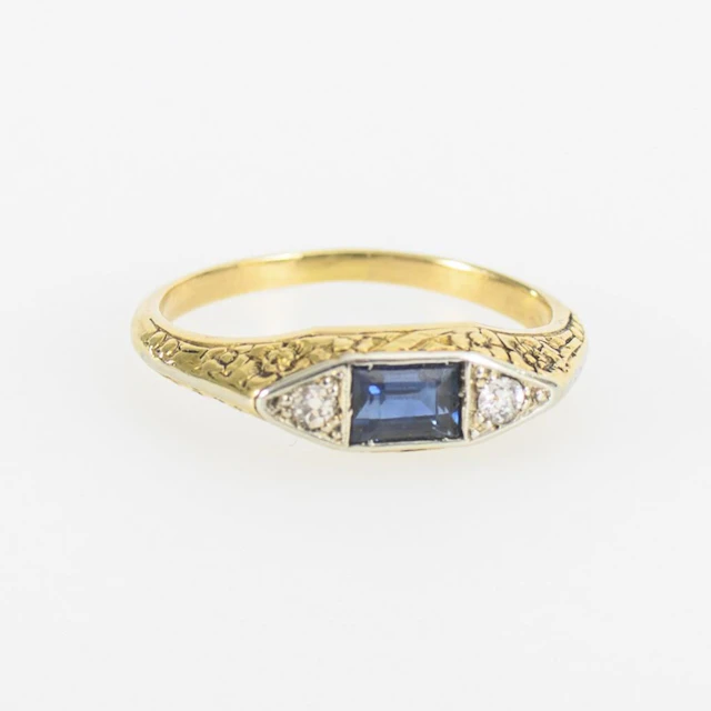 Antique ring with a blue gemstone, likely a sapphire, and 2 diamonds.