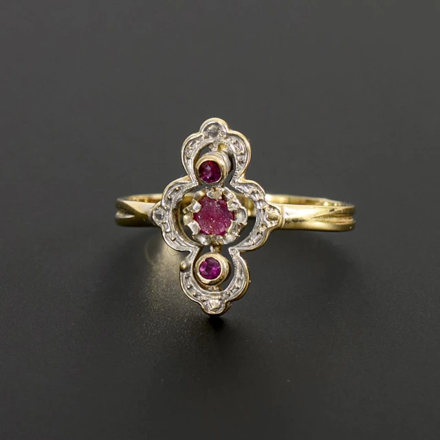 Art Nouveau ring with red gemstones.