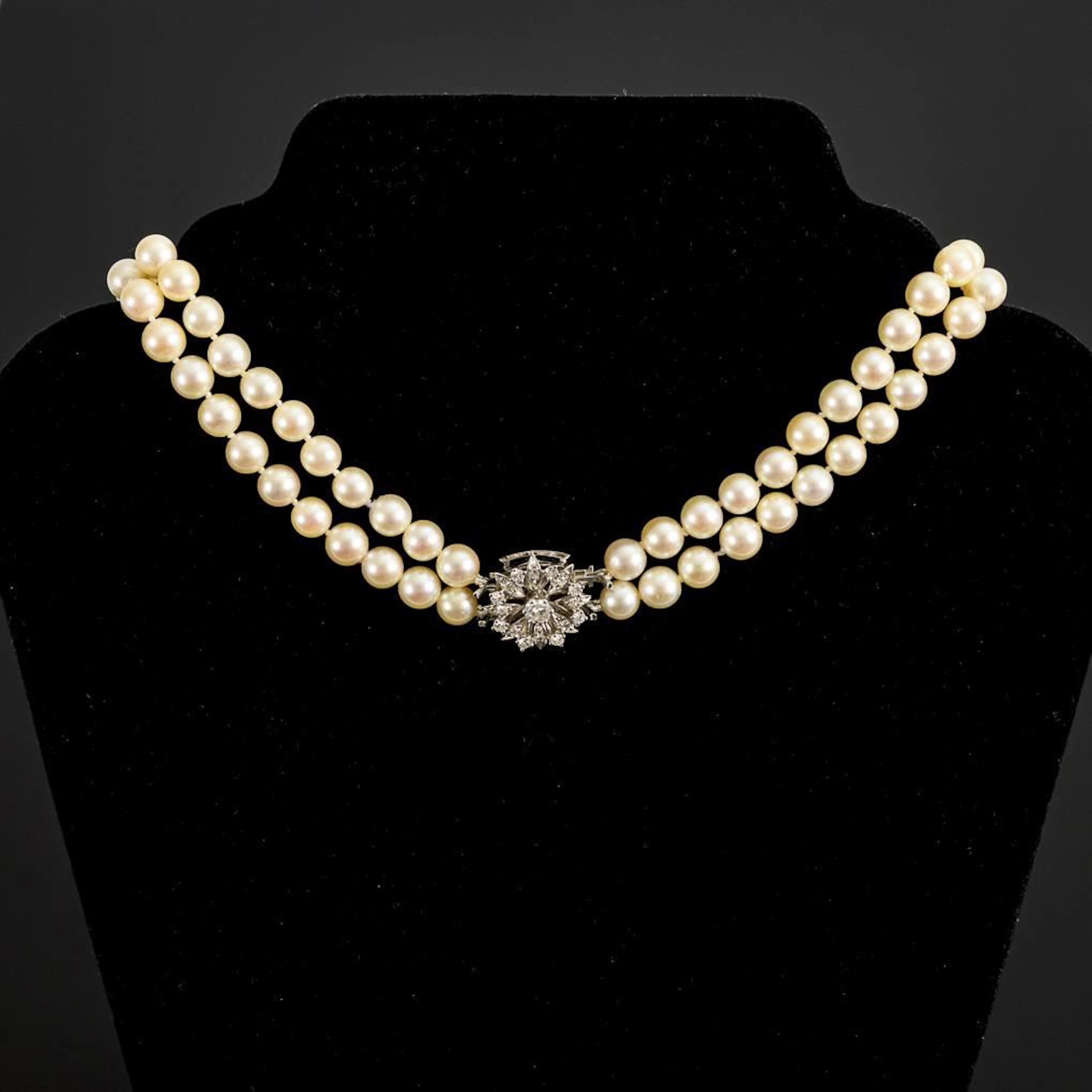 Double-row pearl necklace with a flower-shaped white gold clasp.