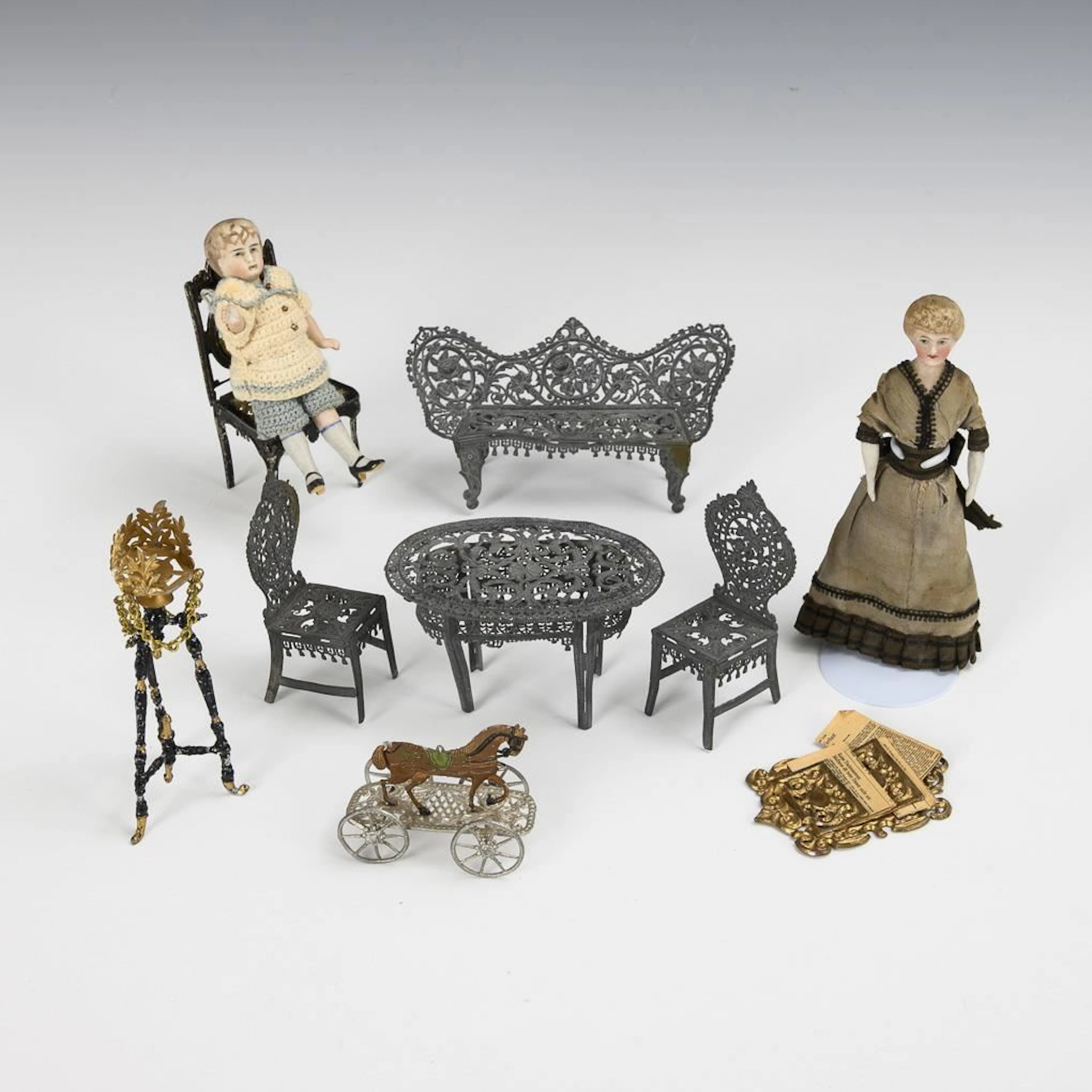 Set of 8 tin furniture pieces and 2 little dolls.