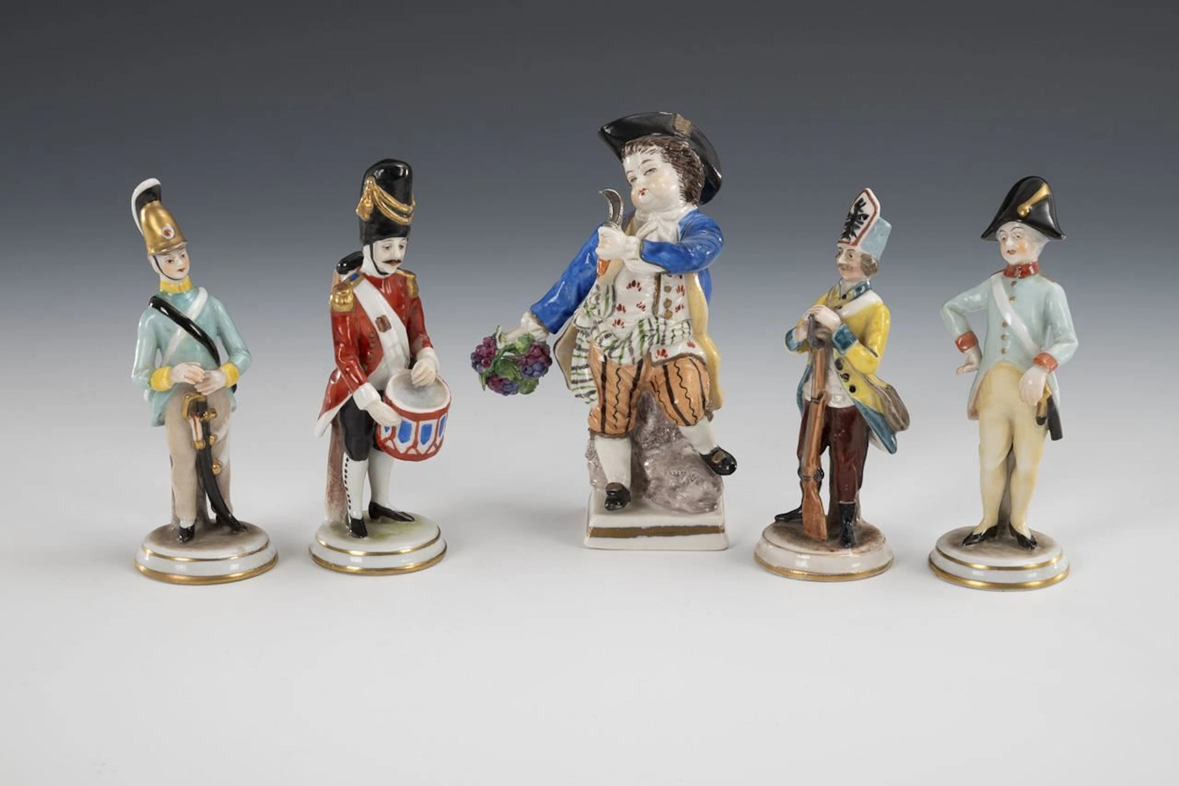 4 small soldier figurines and 1 gardener boy.